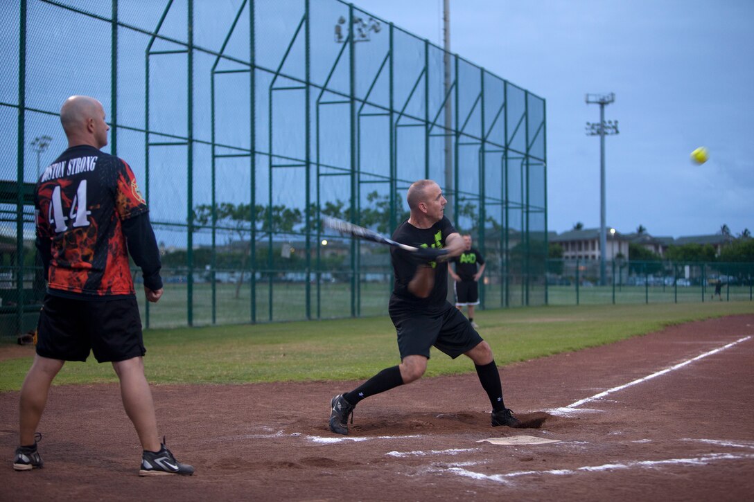 MARINE CORPS BASE HAWAII - A Provost Marshal’s Office intramural softball team player swings at a pitch during a game against Marine Corps Air Station Kaneohe Bay team at Annex Field, June 3. (U.S. Marine Corps photo by Lance Cpl. Suzanna Lapi)