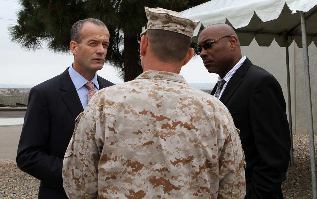 Mario Sierra, left, deputy director of Environmental Services, San Diego speaks with Lt. Col. Eric Wolf, center, director of installations and logistics for Marine Corps Air Station Miramar, Calif., and James Charles, right, director of operations with Fortistar, ® during a celebration of the anniversary of the first use of the Miramar Landfill's methane-powered generators during a ceremony at the Miramar Landfill, San Diego, June 7. During the celebration officials spoke of what has happened in the past year with the landfill, and how the air station is generating in renewable energy from it.