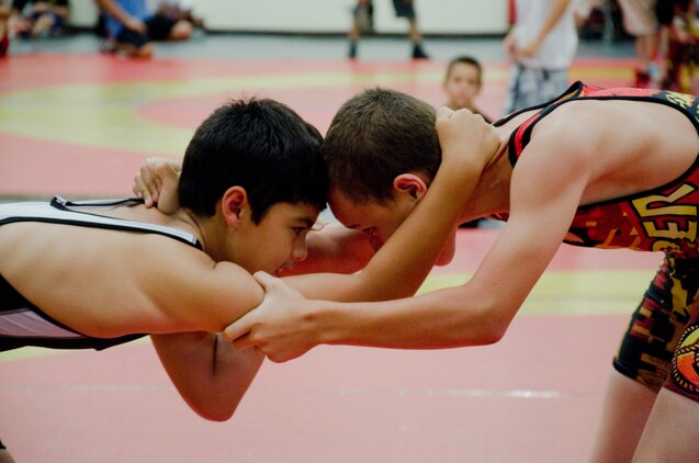 Trojan Athletic Club wrestler Kai Roden (left) faces off against Semper Fit Wrestling Hawaii Bulldog Curtis Fox, at the Semper Fit Center gym, June 1, 2013. (U.S. Marine Corps photo by Kristen Wong)