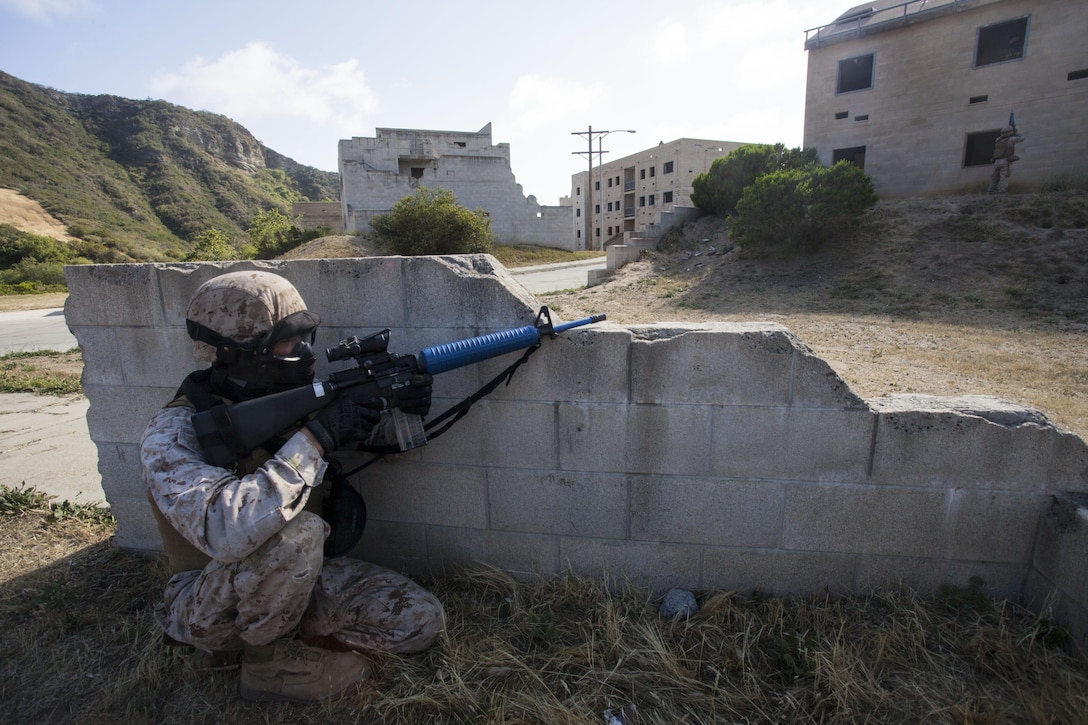 The Marines and Sailors of Headquarters and Headquarters Squadron, Marine Corps Air Station Yuma, Ariz., completed the final training event of the deployment for training exercise at Range 131 aboard Camp Pendleton, San Diego, Calif., May 16. The training exercise culminated with a real-time, live action simulated scenario with Special Effects Small Arms Marking System rounds.  Marines ran their formations in fire teams of four and broke off into pairs of two as a strategic game plan to go building to building until taking their objective. 
