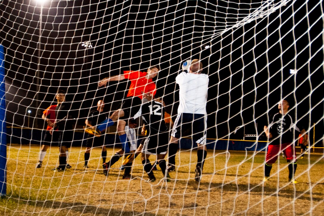 VANDENBERG AIR FORCE BASE, Calif. – Lt. Col. Gerald Mulhollen, 30th Security Forces Squadron commander, blocks a header from Airman 1st Class John Rivera, 381st Training Support Squadron knowledge operation manager, during a soccer championship here Thursday, June 6, 2013.  The 14th AF became the soccer champions after defeating the 30th SFS with a final score of 4-1 for the win.  (U.S. Air Force photo/Airman Yvonne Morales)