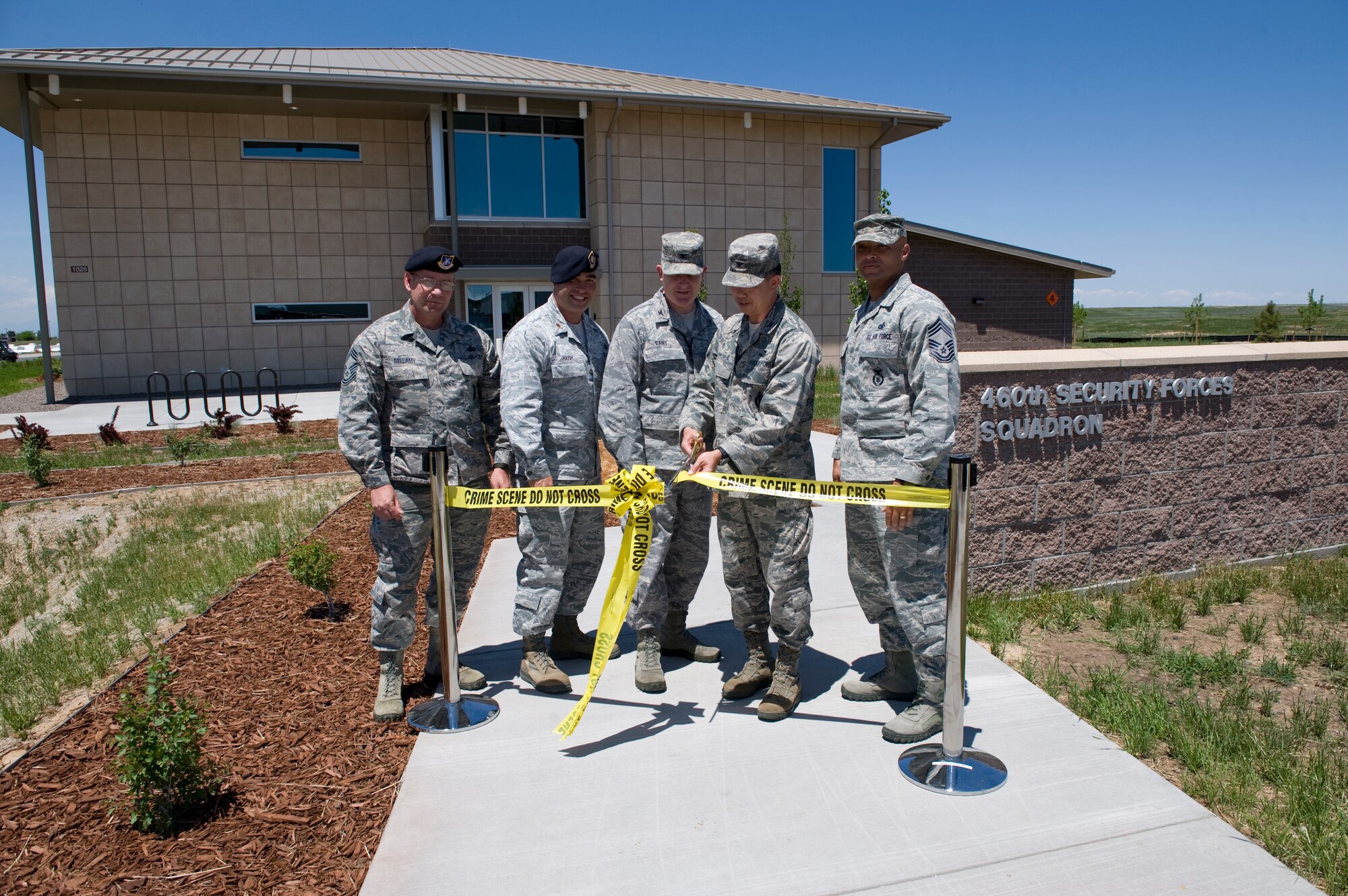 Leadership from the 460th Space Wing and 460th Mission Support Group cut the ribbon during the ribbon-cutting ceremony for the new 460th Security Forces Squadron building June 6, 2013, on Buckley Air Force Base. Thebuilding was designed to be Leader in Energy and Environmental Design certified. It includes using natural lighting and a heat pump that can be used year round to both heat and cool the building. (U.S. Air Force photo by Senior Airman Phillip Houk/Released)