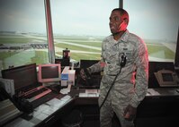 Senior Airman Brian Kelly, an air traffic controller in the 802nd Operations Support Squadron, gives a pilot landing instructions from the Kelly Field control tower.   (U.S. Air Force photo by Robbin Cresswell)
