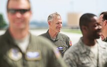 Col. David Almand, 375th Air Mobility Wing commander, is congratulated by the Airmen he has commanded over the past year following his fini-flight as wing commander at Scott Air Force Base, Ill. June 6, 2013. A commander's fini-flight is an Air Force tradition meant to honor and thank the commander for his service. Almand will relinquish his command of the 375th at a change of command ceremony 14 June, 2013.(U.S. Air Force photo/ Staff Sgt. Ryan Crane)