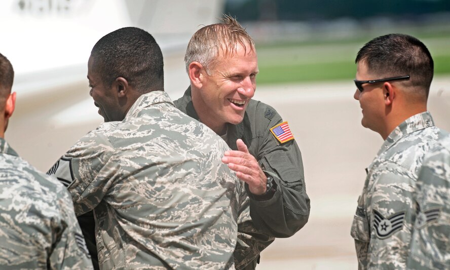 Col. David Almand, 375th Air Mobility Wing commander, is congratulated by the Airmen he has commanded over the past year following his fini-flight as wing commander at Scott Air Force Base, Ill. June 6, 2013. A commander's fini-flight is an Air Force tradition meant to honor and thank the commander for his service. Almand will relinquish his command of the 375th at a change of command ceremony 14 June, 2013.(U.S. Air Force photo/ Staff Sgt. Ryan Crane)