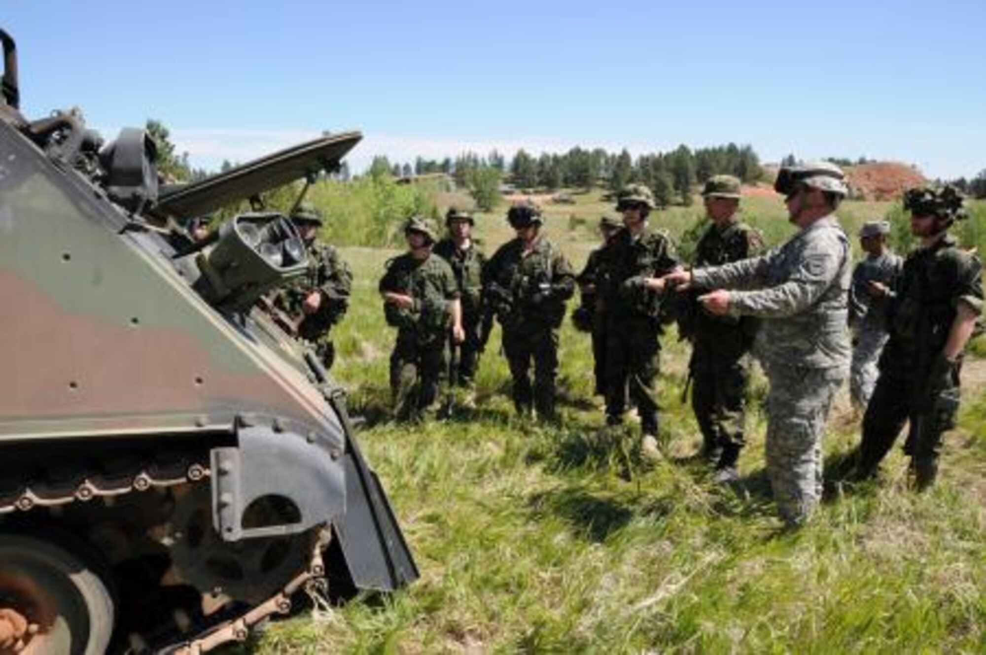 Staff Sgt. Matthew D. Ernster, HHC 153rd EN BN out of Huron, S.D., instructs Danish Home Guard soldiers on the M113 armored personnel carrier during Golden Coyote, June 14, 2012 at West Camp Rapid, Rapid City, S.D. (U.S. Army photo by Spc. Amber Hoy/Released)