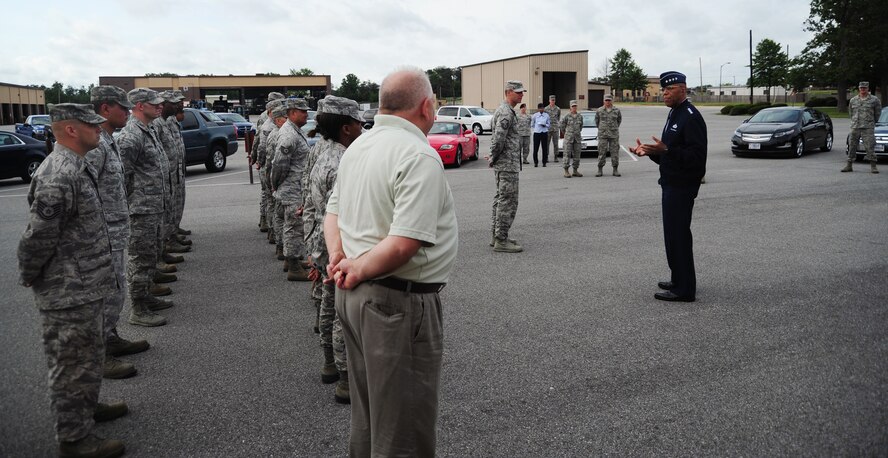 Vice Chief of Staff of the Air Force Gen. Larry Spencer speaks with Airmen from the 11th Logistics Readiness Squadron June 6, 2013, on Joint Base Andrews, Md. Spencer coined four Airmen who collaborated on an idea to save the Air Force money. The Airmen found less expensive leases for distinguished visitor transport vehicles, which will save more than $10,000 per year. (U.S. Air Force photo/Airman 1st Class Erin O’Shea) 