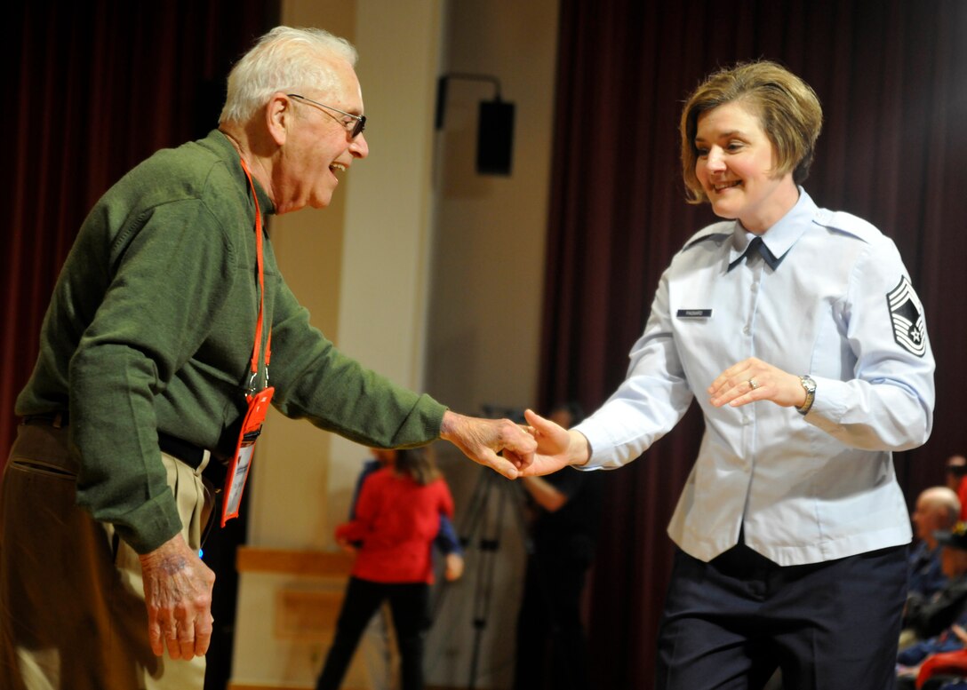 Chief Master Sgt. Jennifer Pagnard, chief of marketing and outreach for The U.S. Air Force Band, dances with a World War II veteran during an Honor Flight visit to Joint Base Anacostia-Bolling April 20, 2013. The Airmen of Note, The U.S. Air Force Band's premiere jazz ensemble, performed for the flight during their tour of Washington, D.C.  (U.S. Air Force photo/Senior Airman Lindsey A. Porter)