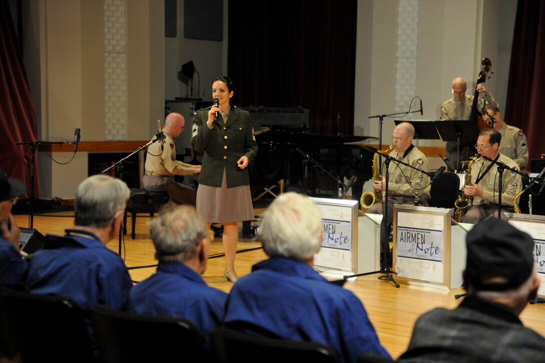 Singing above the crowd's whistles of appreciation, Tech. Sgt. Emily Wellington, member of The U.S. Air Force Band's Singing Sergeants, performs with The Airmen of Note for an Honor Flight of World War II veterans at Joint Base Anacostia-Bolling April 20, 2013. During their visit, members of the Honor Flight were afforded the opportunity to hear a live performance given by The Airmen of Note, The U.S. Air Force Band's premiere jazz ensemble (U.S. Air Force photo/Senior Airman Lindsey A. Porter)