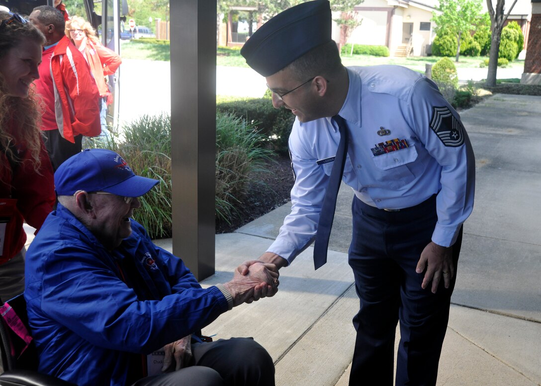 Cheif Master Sgt. Craig LeDoux, The U.S. Air Force Band manager, greets a member of a Dallas Honor Flight at Joint Base Anacostia-Bolling April 20, 2013. The goal of the nation-wide Honor Flight program is to help every single veteran in America, willing and able of getting on a plane or a bus, to visit their respective national war memorial. (U.S. Air Force photo/Senior Airman Lindsey A. Porter)