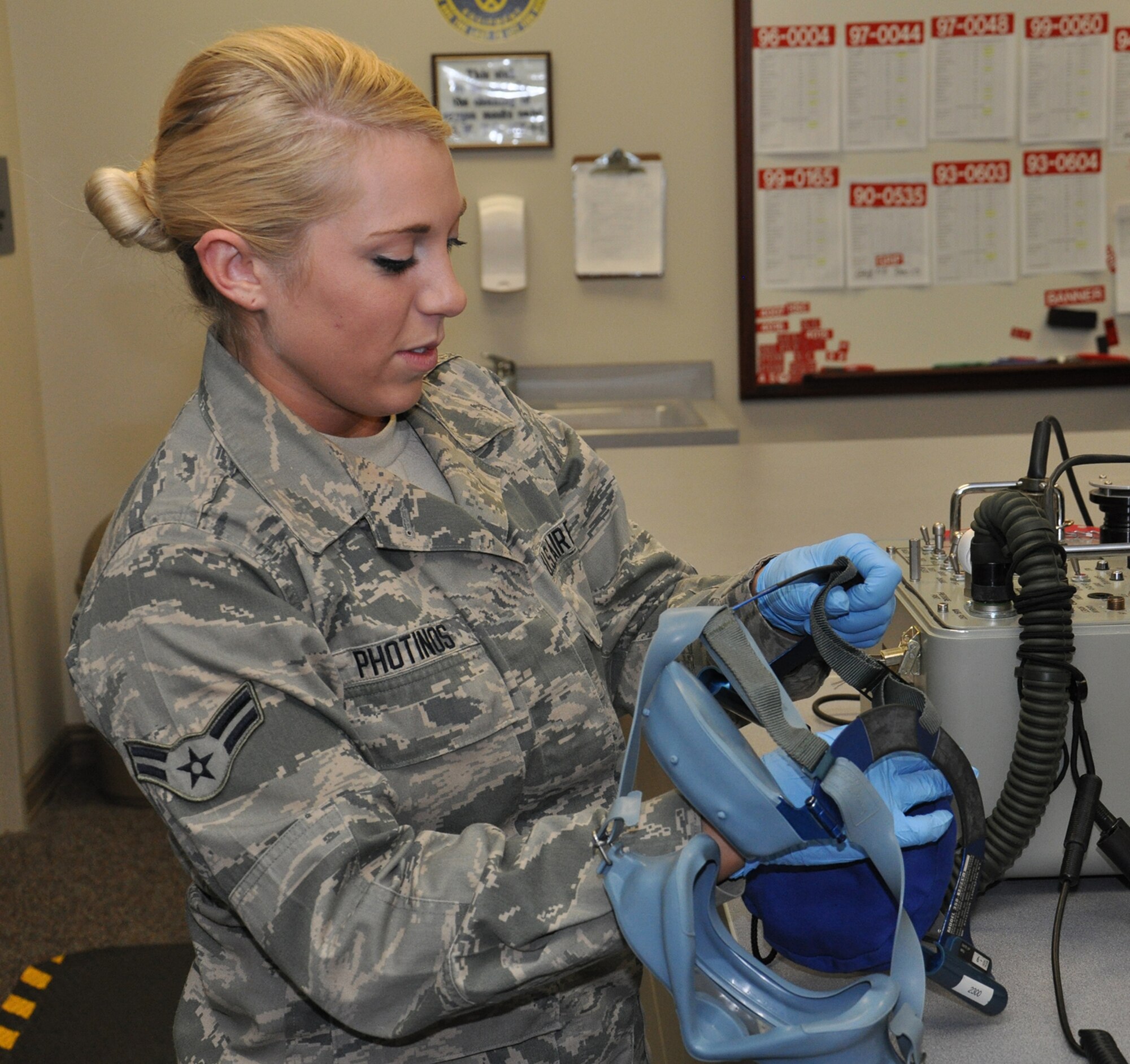 WRIGHT-PATTERSON AIR FORCE BASE, Ohio - Airman 1st Class Cecilia Photinos sanitizes and tests an oxygen mask as part of a 30-day pre-flight inspection. C-17 aircrew members use the Quik Don 358 oxygen mask in case of an emergency during the loss of cabin pressure or cabin smoke. (U.S. Air Force photo/Senior Airman Devin Long)