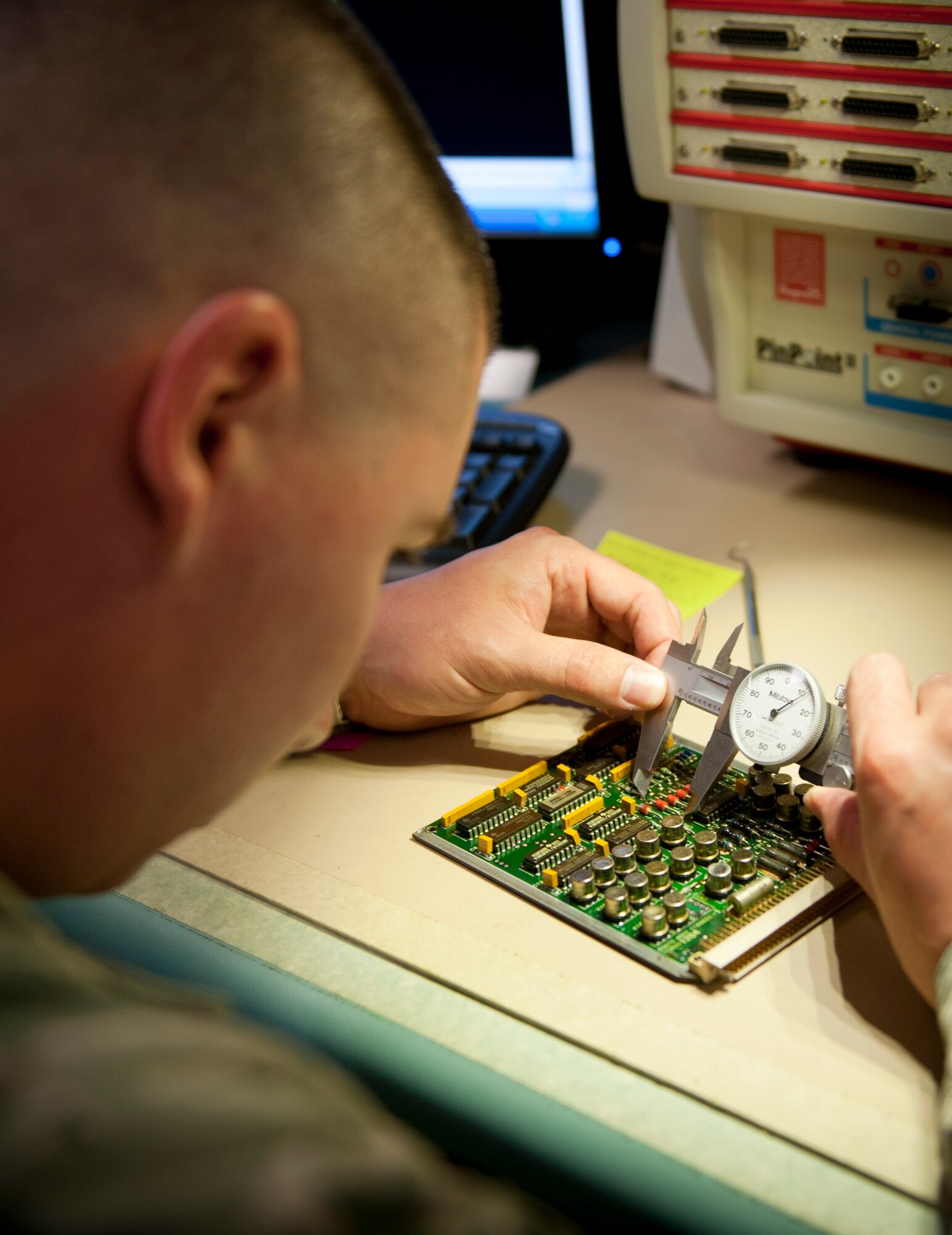 U.S. Air Force Staff Sgt. Bradley Cooper, Air Force Repair Enhancement Program technical analyst, uses a caliber to measure components on a relay circuit card assembly at the AFREP shop on Hurlburt Field, Fla. May 30, 2013. On average, the AFREP shop saves the Air Force $ 1 million per fiscal year. (U.S. Air Force photo by Senior Airman Krystal M. Garrett) 