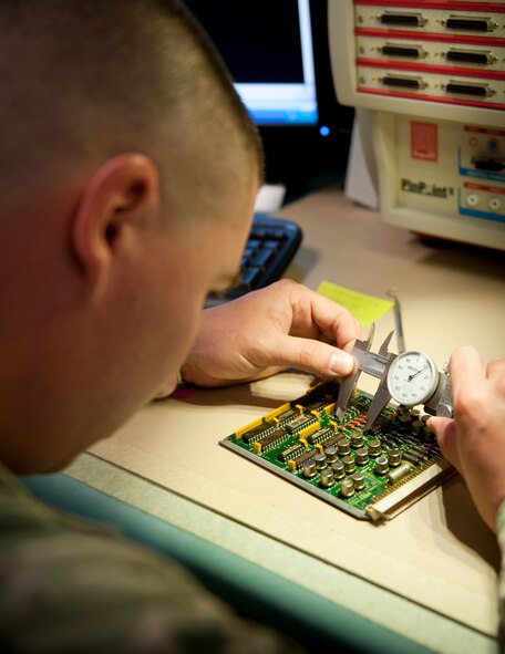 Staff Sgt. Bradley Cooper, Air Force Repair Enhancement Program technical analyst, measures components on a relay circuit card assembly at the AFREP shop on Hurlburt Field, Fla. May 30, 2013. On average, the AFREP shop saves the Air Force $ 1 million per fiscal year. (U.S. Air Force photo by Senior Airman Krystal M. Garrett) 