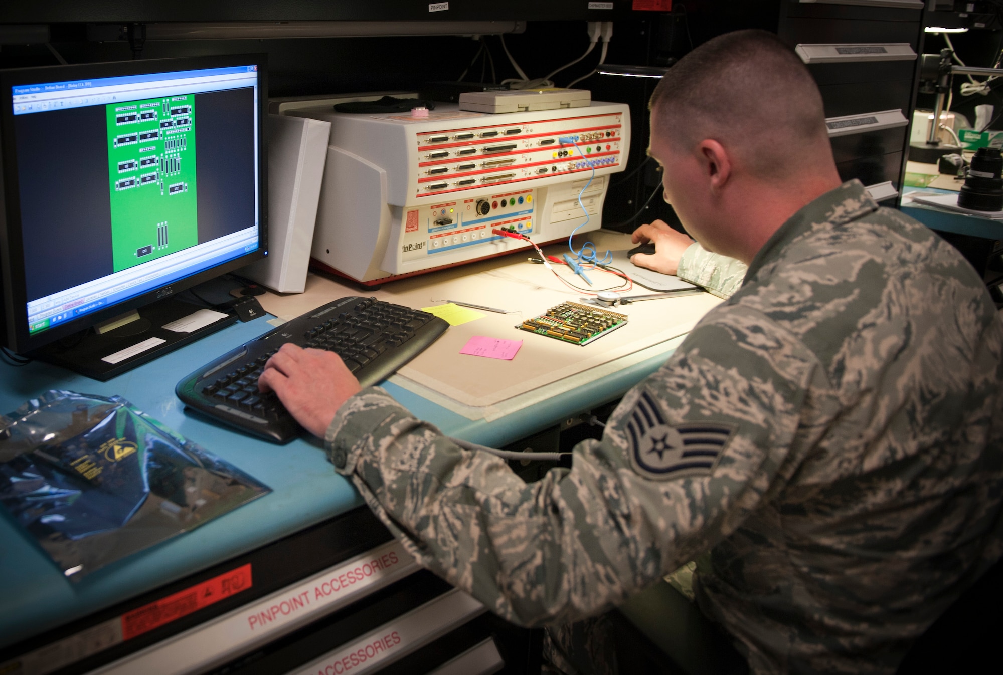 U.S. Air Force Staff Sgt. Bradley Cooper, Air Force Repair Enhancement Program technical analyst, uses a pin point machine to perform diagnostic troubleshooting on a relay circuit card assembly at the AFREP shop on Hurlburt Field, Fla. May 30, 2013. The AFREP shop is a unit within the 1st Special Operations Maintenance Squadron. (U.S. Air Force photo by Senior Airman Krystal M. Garrett) 