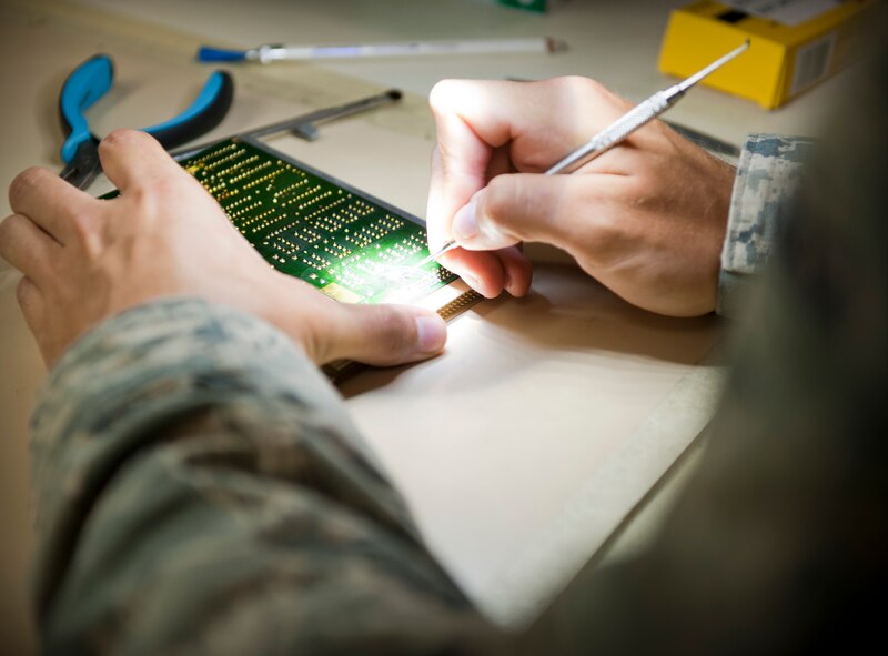 U.S. Air Force Staff Sgt. Kenneth Derkatz, Air Force Repair Enhancement Program technical analyst, performs an initial evaluation on a relay switch board at the AFREP shop on Hurlburt Field, Fla. May 30, 2013. The AFREP shop takes items that are to be thrown away or sent to the Defense Reutilization and Marketing Office and repairs them, saving the Air Force money.  (U.S. Air Force photo by Senior Airman Krystal M. Garrett) 