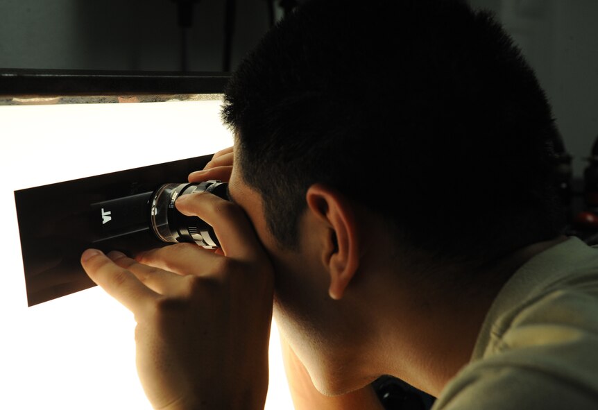 Airman 1st Class Leonard Avalos, 2nd Maintenance Squadron non-destructive inspection, inspects a piece of film on Barksdale Air Force Base, La., June 7, 2013. NDI Airmen verify the film accurately recorded the piece of equipment being inspected. (U.S. Air Force photo/Airman 1st Class Benjamin Gonsier)