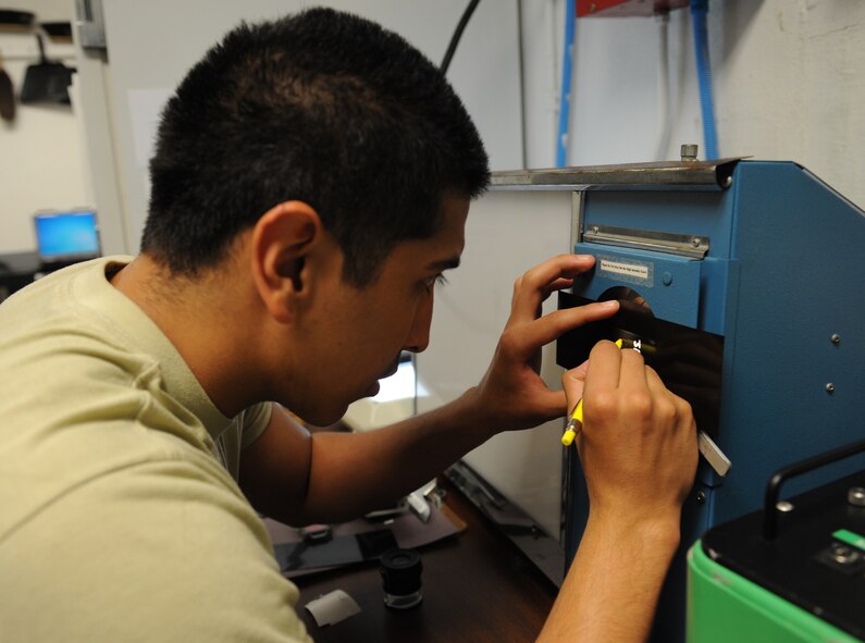 Airman 1st Class Leonard Avalos, 2nd Maintenance Squadron non-destructive inspection, marks a portion of a piece of film on Barksdale Air Force Base, La., June 7, 2013. The NDI section uses ultrasound and x-rays to pinpoint damage to aircraft parts. (U.S. Air Force photo/Airman 1st Class Benjamin Gonsier)