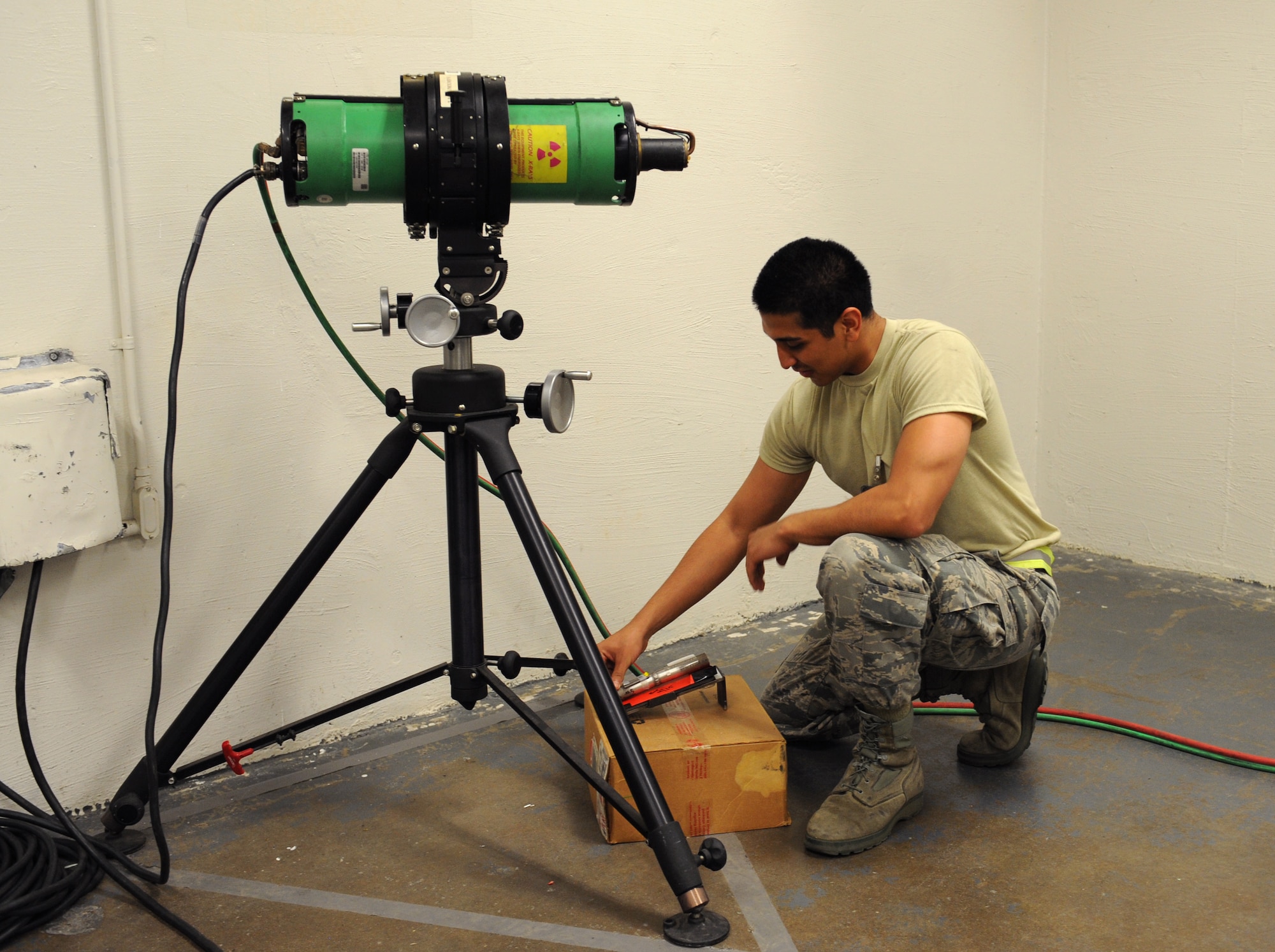 Airman 1st Class Leonard Avalos, 2nd Maintenance Squadron non-destructive inspection, places a weld under an X-radiation machine on Barksdale Air Force Base, La., June 7, 2013. A piece of film is placed under the weld and the X-ray machine will shoot radiation towards it. The weld will be printed on the film for Airmen to properly inspect the piece. (U.S. Air Force photo/Airman 1st Class Benjamin Gonsier) 