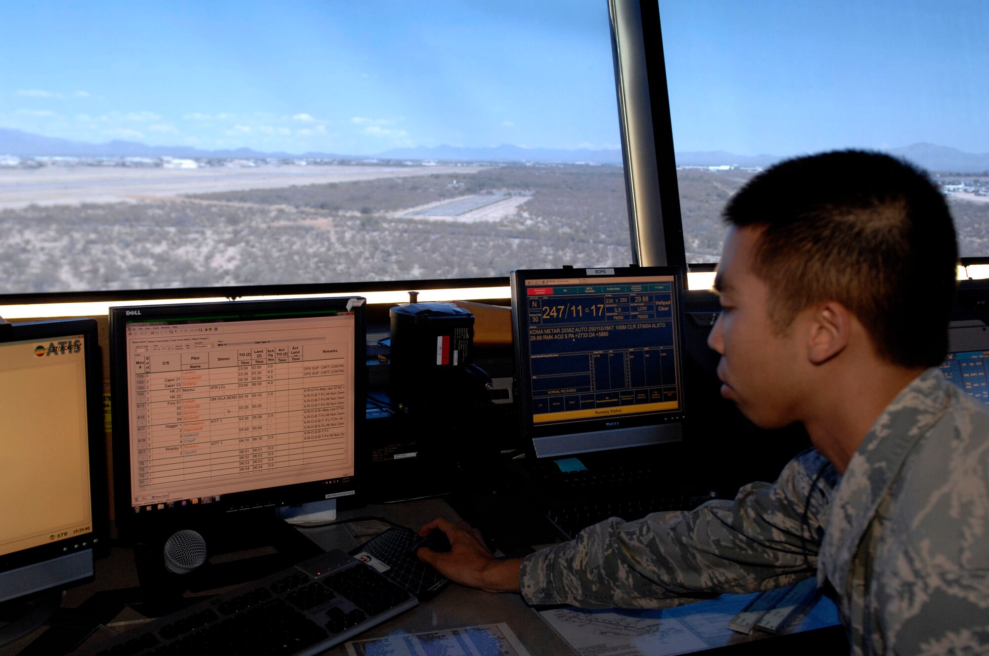 U.S. Air Force Airman 1st Class Danny Ho, 355th Operations Support Squadron air traffic controller, checks the Airfield Automated System from the cab of the air traffic control tower at Davis-Monthan Air Force Base, Ariz., June 4, 2013. The automated system acts as a status board, allowing controllers to view essential information such as aircraft positions on the flightline and wind speeds. (U.S. Air Force photo by Airman 1st Class Saphfire Cook/Released)