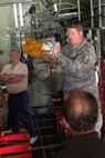 Air Force Reserve Master Sgt. Daniel Scott, a crew chief with the 910th Maintenance Squadron, opens an emergency oxygen bag as part of a C-130 tour here June 7, 2013.  U.S. Air Force photo/Maj. Brent J. Davis