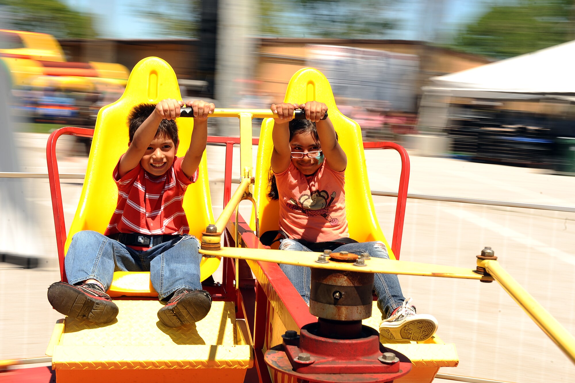 Siblings Sal and Julieta Chavez, children of U.S. Air Force Staff Sgt. Sal Chavez, U.S. Strategic Command, go for a spin on the G-Force ride at the Base Lake during the annual Appreciation Day Picnic on May 31, Offutt Air Force Base, Neb. In addition to the G-Force ride, the Offutt Advisory Council had a rock wall, pony rides, face painting and several large bounce houses for the children to enjoy. (U.S. Air Force photo by Josh Plueger/Released)