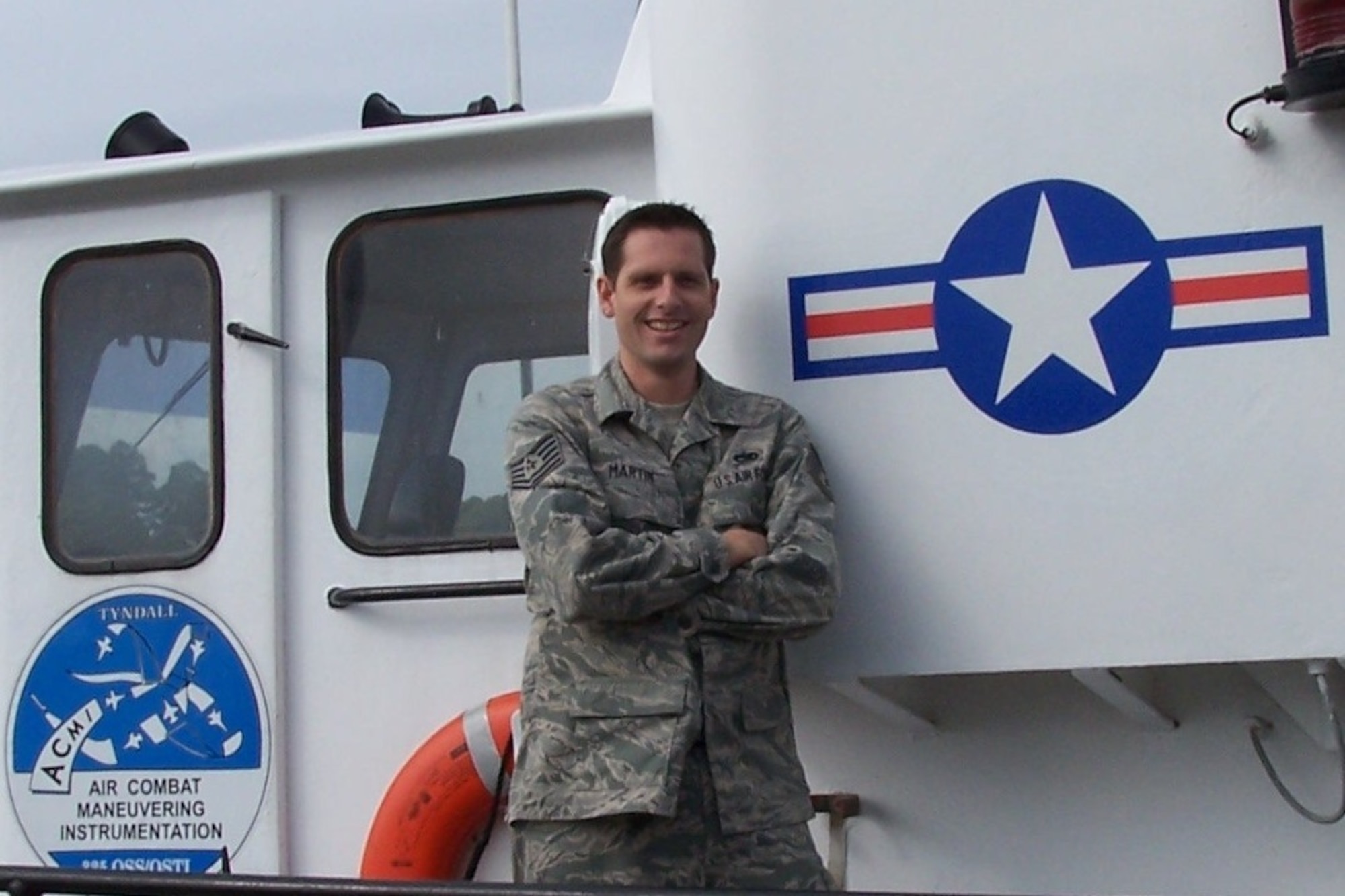 Tech. Sgt. Timothy Martin, 325th Training Support Squadron quality assessment evaluator, poses for a photo on his unit’s Air Combat Maneuvering Instrumentation boat by Carrabelle Island, Fla. (Courtesy photo)