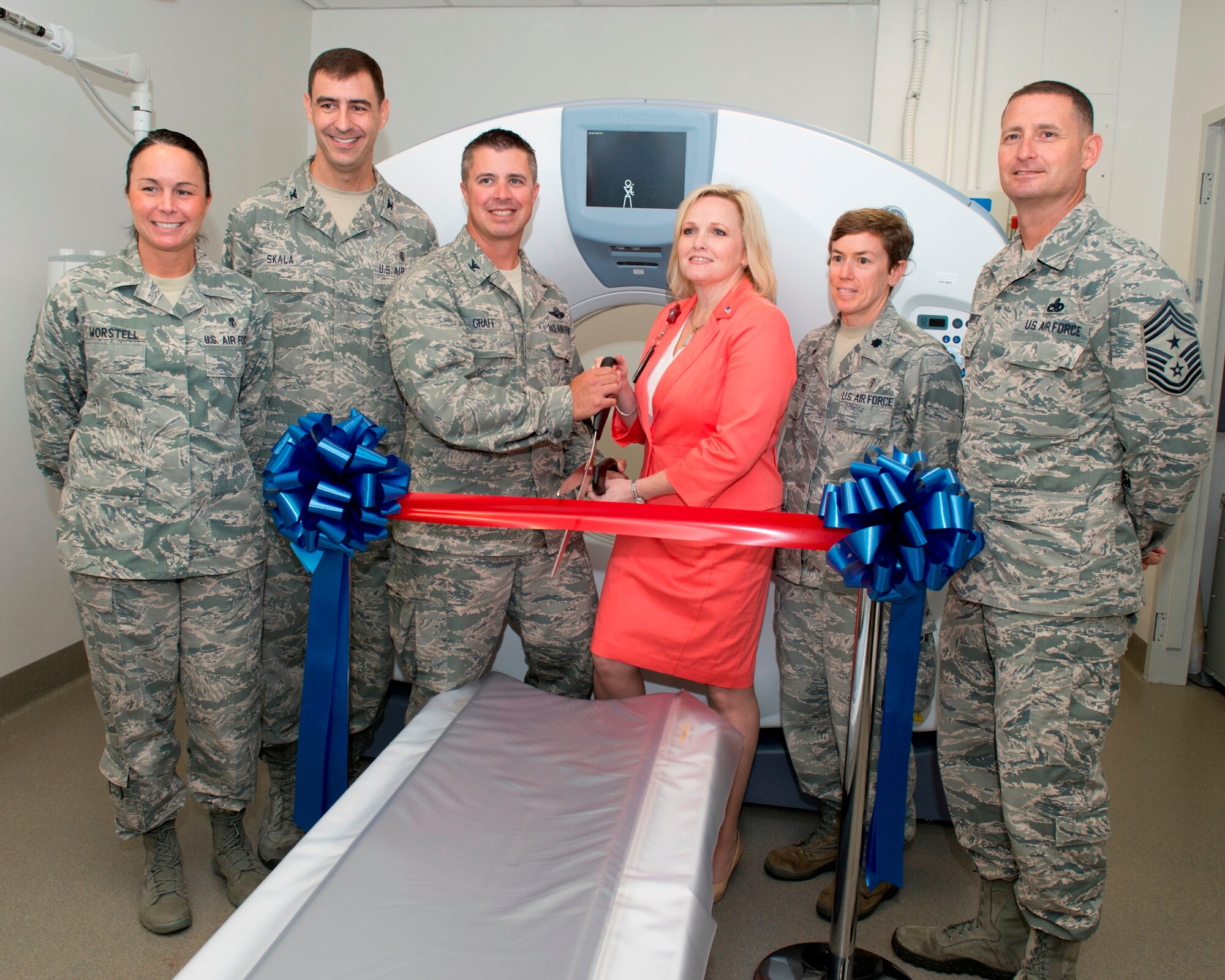 Colonel David E. Graff (center), 325th Fighter Wing commander, and Cindy Cook (center), VA Gulf Coast Veterans Health Care System’s VA/DOD resource sharing coordinator, prepare to cut the ribbon to reveal renovations, new technology and to symbolize the 325th Medical Group’s new partnership with the Department of Veterans Affairs during a ribbon cutting ceremony at the radiology department June 6. Colonel Paul Skala (back left), 325th MDG commander, Lt. Col. Shannon Phares (right), 325th Medical Support Squadron commander, Chief Master Sgt. Raymond DeVite Jr. (right), 325th FW command chief, and Senior Master Sgt. Jody Worstell (left), 325th MDG superintendant, also posed for the photo. (U.S. Air Force photo by Lisa Norman) 