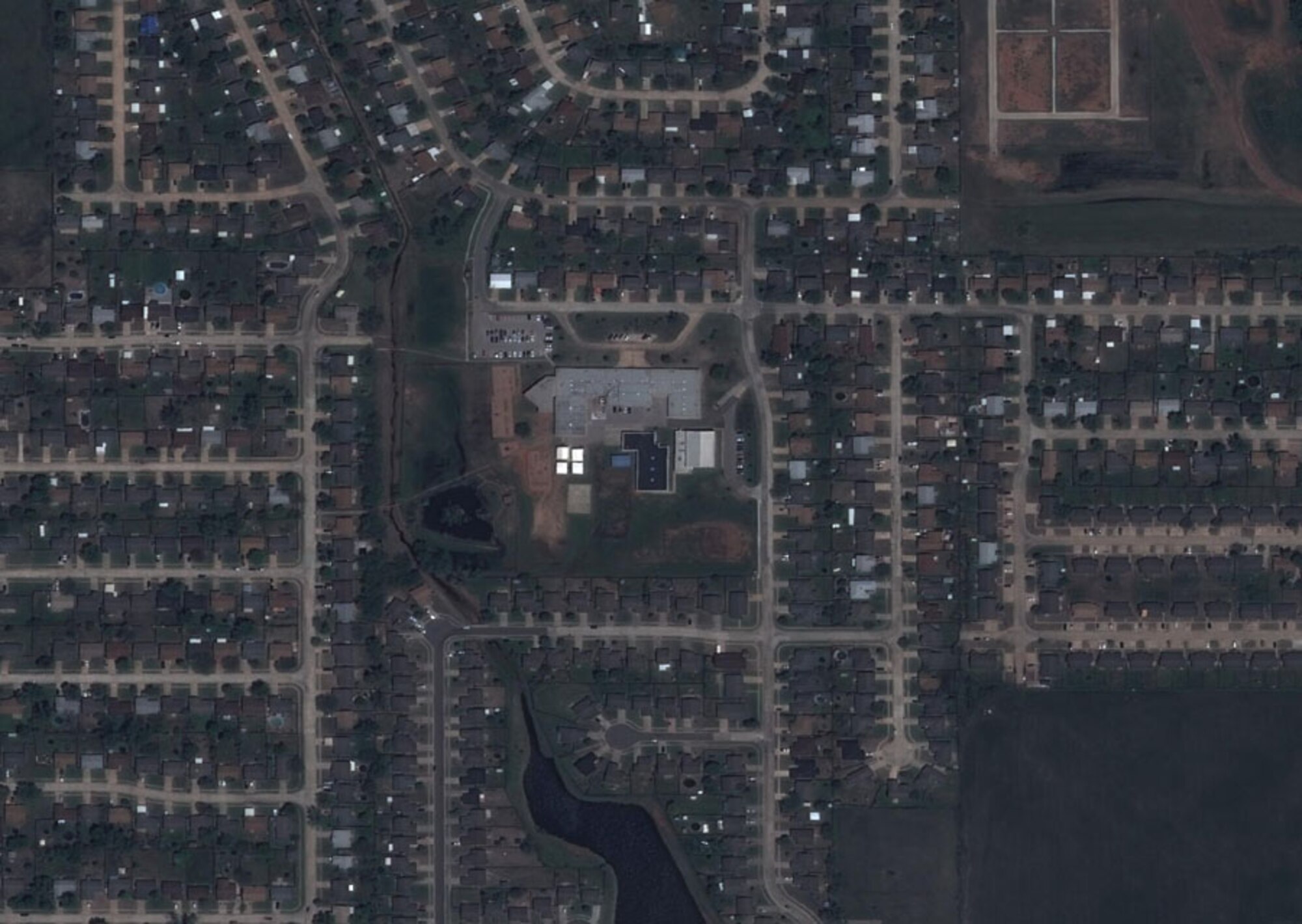 HANSCOM AIR FORCE BASE, Mass. - Satellite imagery captured by Hanscom's Eagle Vision program shows the town of Moore, Okla., with the Plaza Towers Elementary School in the center, before the May 22 tornado that devastated the region. The next image shows the same area following the tornado. This imagery can be used by first responders for disaster relief efforts. The program office is conducting a cost-savings review to find savings within the program while ensuring the imagery would still be available when needed. (Courtesy image)
