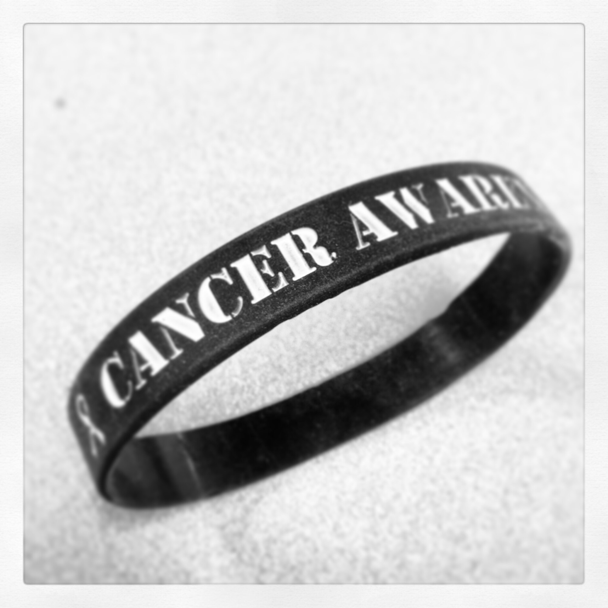 Senior Airman Taylor Lilley, former 319th Security Forces Squadron member, as well as other unit members, sold bracelets like the one shown here as a fundraiser recently to benefit cancer patients at the Altru Cancer Center in the city of Grand Forks. (U.S. Air Force photo illustration/Staff Sgt. Susan L. Davis)