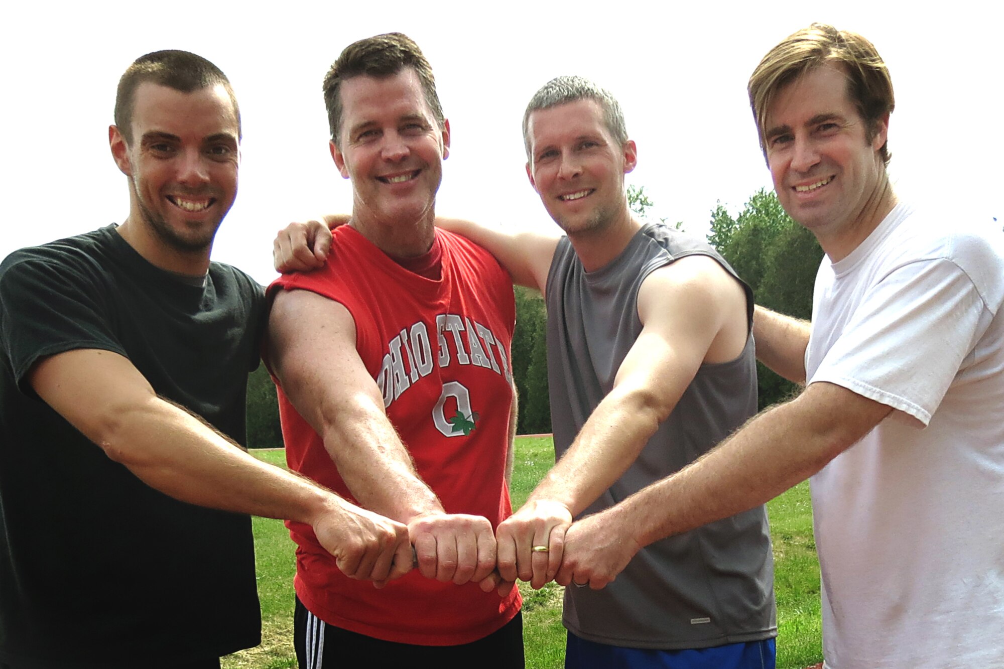 GRISSOM AIR RESERVE BASE, In. -- From the left, Chris Wiley, Rich Percival, Cory Walters, and Zac Holmes, members of the 4x600-meter relay celebrate their victory during a track day held here May 16. May was fitness month, and the gym staff held many activities to celebrate. (U.S. Air Force photo/Becca Hammer)