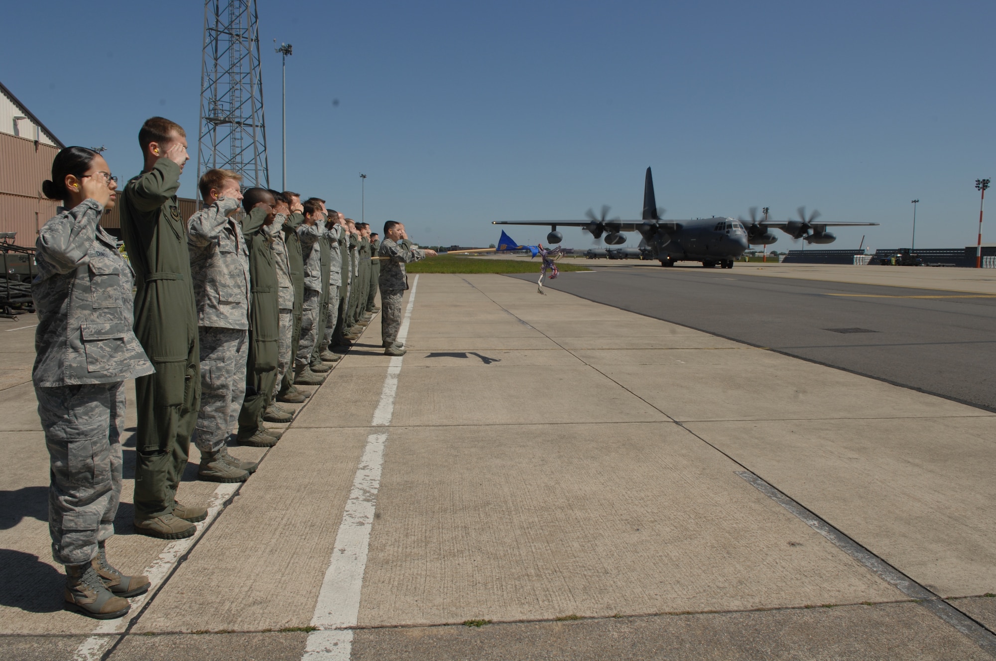 Members of the 67th Special Operations Squadron salute as their first MC-130J Commando II arrives at RAF Mildenhall, England, June 7, 2013. The arrival of the MC-130J to the 352nd Special Operations Group marks an increased ability to execute military operations including infiltration, exfiltration and resupply.  (U.S. Air Force photo by Airman 1st Class Dillon Johnston/Released)