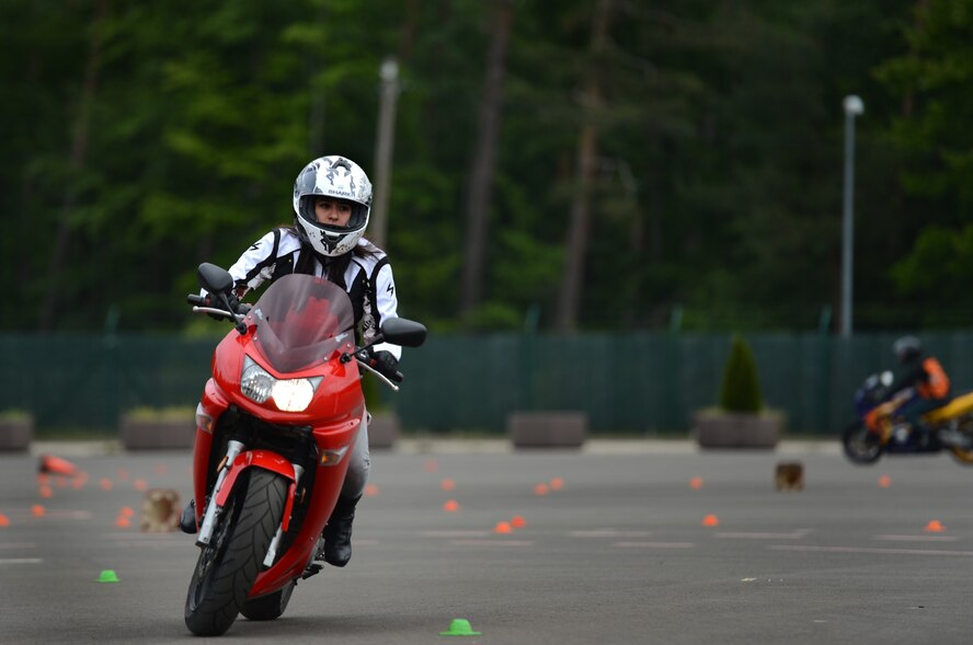 Airman 1st Class Vanessa Escobar, 721st Air Port Squadron processing specialist, rides her motorcycle during the motorcycle safety day event, June 1, 2013, Kapaun, Germany. Throughout the day, certified German instructors guided individuals through various workshops, which include positioning, observation, braking, as well as lapping sessions on the practice course. (U.S. Air Force photo/Senior Airman Aaron-Forrest Wainwright)