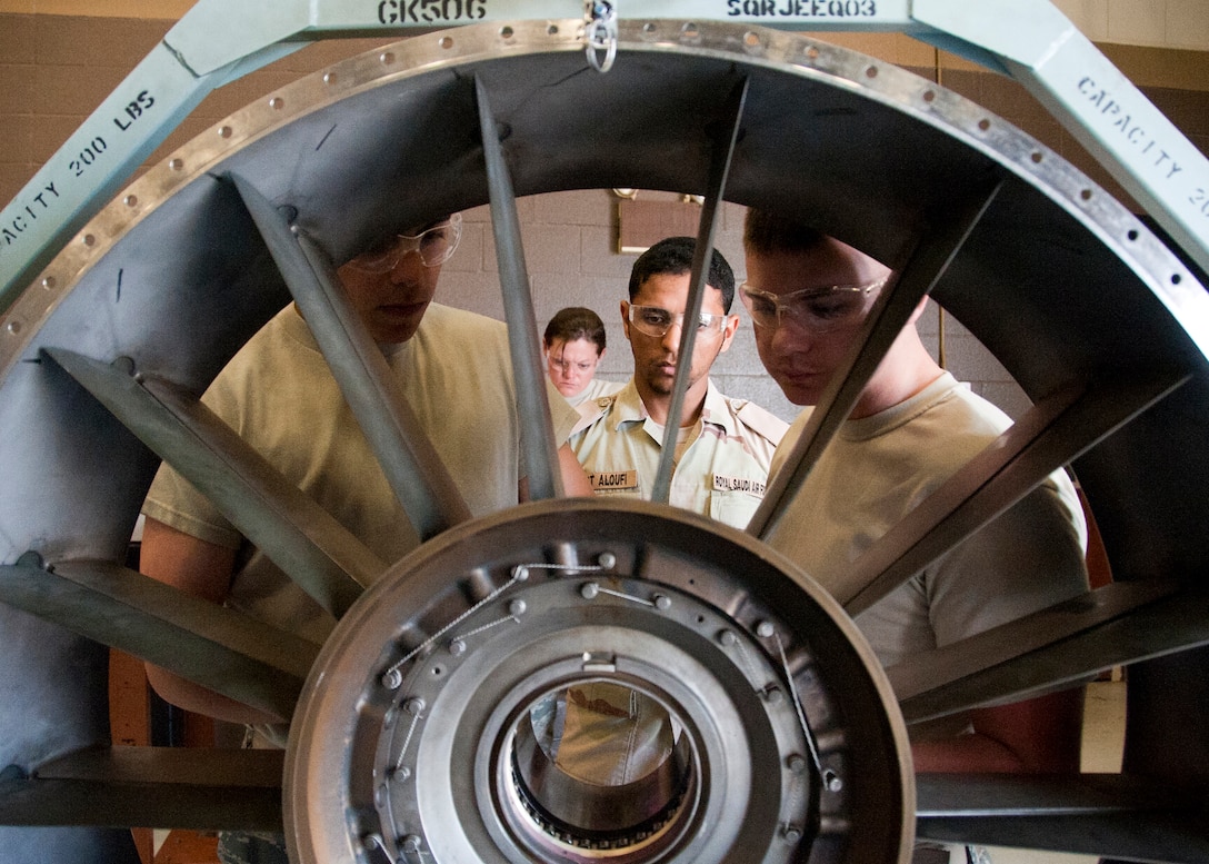 U.S. Air Force Airman 1st Class Cody Greer, Royal Saudi Air Force Staff Sgt. Barjas Aloufi and Airman Maxwell Crowe, 361st Training Squadron, Aerospace Propulsion course, are installing a guide tube to prepare a Front Frame Assembly for installation to an F-16 aircraft engine on June 04, 2013 at Sheppard Air Force Base, Texas. (U.S. Air Force photo by Frank Carter)