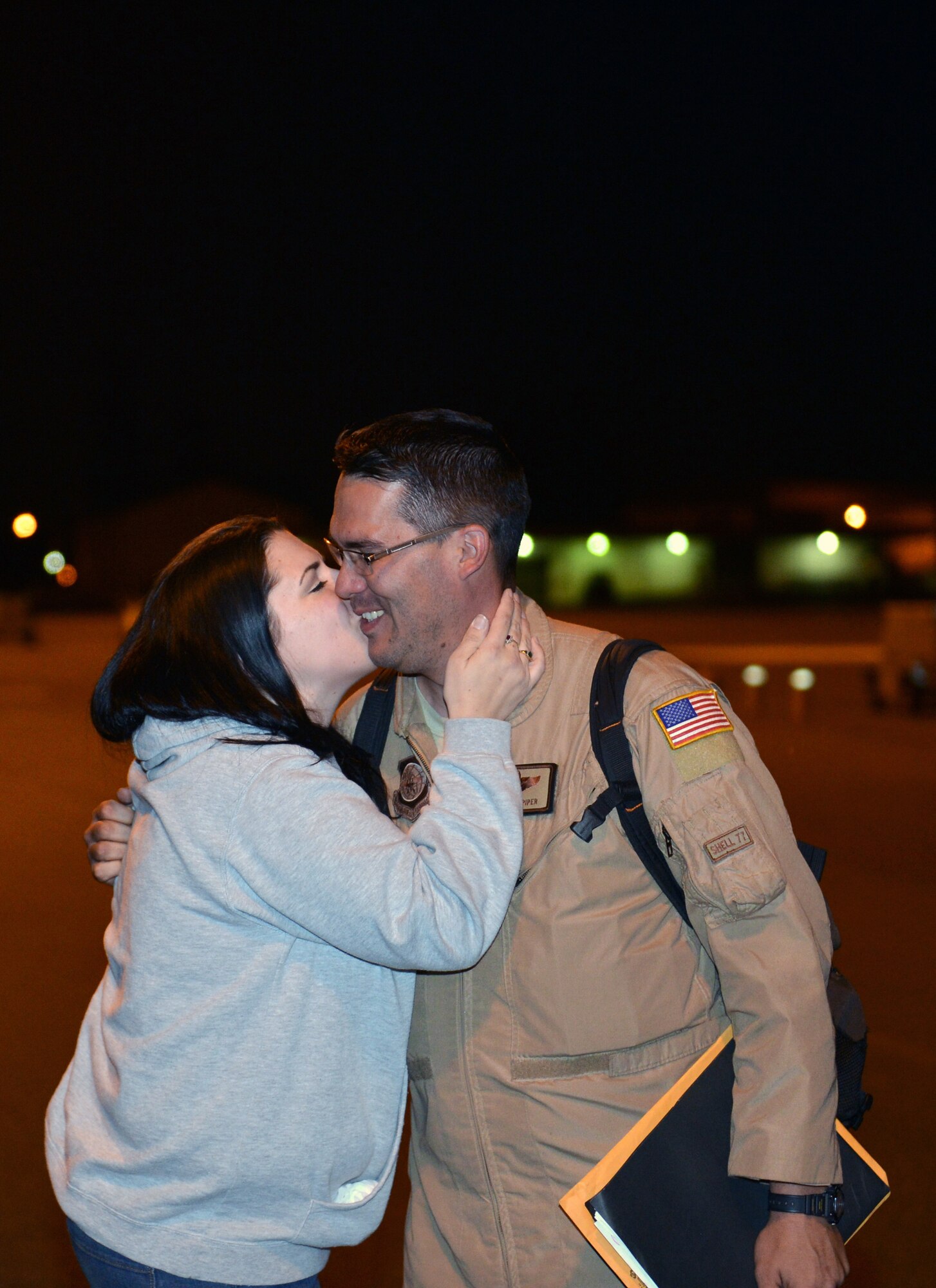 The wife of Tech. Sgt. Joshua Piper, 4th Airlift Squadron loadmaster, kisses him after his return from a deployment June, 6, 2013 at Joint Base Lewis-McChord, Wash. More than 60 Airmen from the 4th AS deployed for 60 days to the Southwest Asia. (U.S. Air Force photo/Staff Sgt. Jason Truskowski)