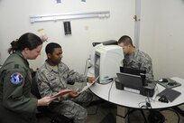 Air Force Capt. Sarah Thomas, 359th Medical Wing flight surgeon, provides guidance to Airman 1st Class James Johnson on performing a visual acuity test May 31, 2013 at the Joint Base San Antonio-Randolph Medical Clinic. (Air Force photo by Don Lindsey/Released)