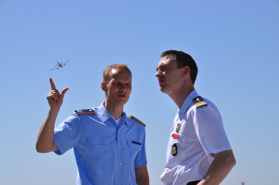 Members of NATO's German Federal Joint Forces Command and Staff College stand Monday on the flightline at Travis Air Force Base, Calif., June 3, 2013, as a KC-10 Extender flies overhead. Approximately 50 students from a German NATO officer school visited Travis as part of a four-site tour of America.(U.S. Air Force photo/Airman 1st Class Madelyn Brown) 

