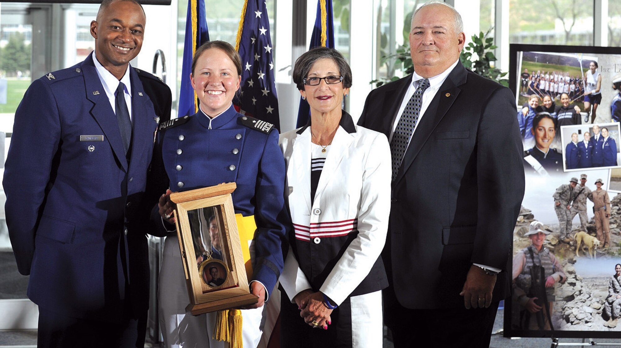 Col. Joseph Sanders III (far left) and Susie and Bob Schulte (right) present Cadet 1st Class Esther Willett with the 1st Lt. Roslyn Schulte Cadet Award for outstanding character and leadership during a ceremony at the Academy’s McDermott Library May 28. Willett, a native of Lancaster, Pa., graduated from the Academy May 29. (U.S. Air Force photo/Raymond McCoy)
