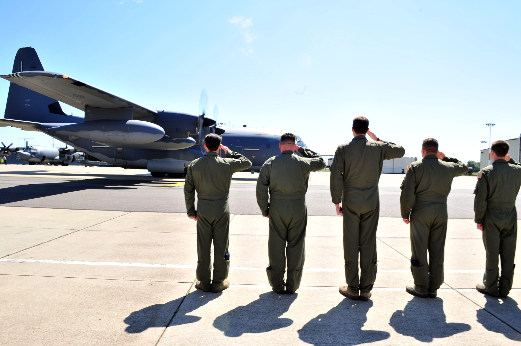 Members from the 67th Special Operations Squadron salute their first MC-130J Commando II June 7, 2013, on RAF Mildenhall, England. The arrival of the MC-130J to the 352nd Special Operations Group marks an increased ability to execute military operations including infiltration, exfiltration and resupply. (U.S. Air Force photo by Tech. Sgt. Stacia Zachary/Released)