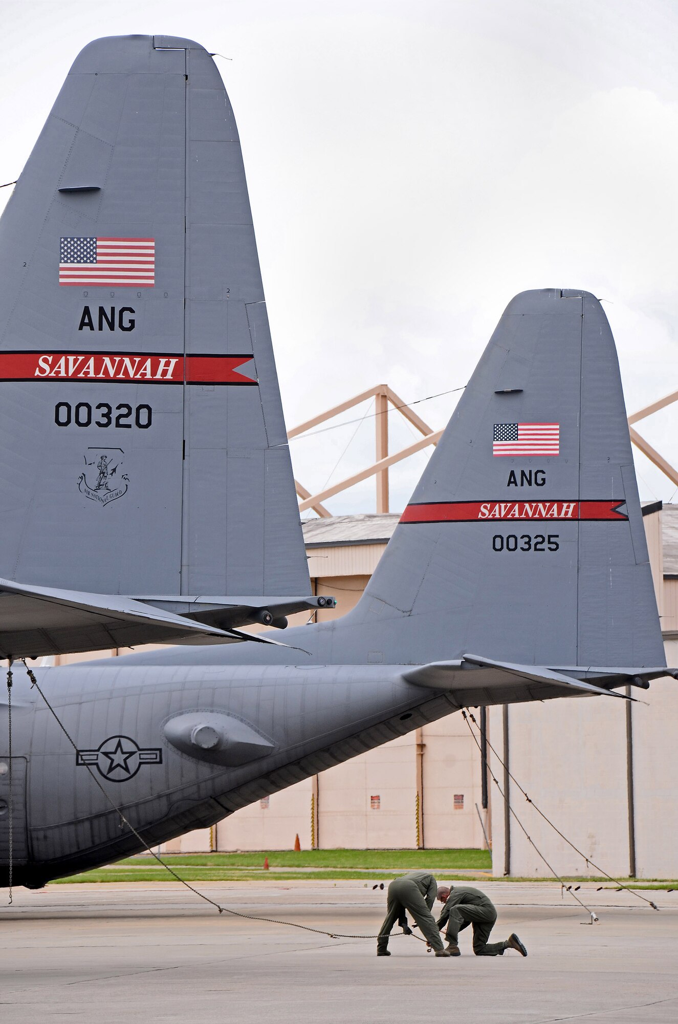 Aircrew members from the 165th Airlift Wing of the Georgia Air Guard at Savannah, tie down a C-130H aircraft after arriving at Dobbins Air Reserve Base, Ga., Jun 6. Three aircraft evacuated from Savannah to Dobbins to avoid the path of tropical storm Andrea as it made its way across Florida and up the east coast. (U.S. Air Force photo/Brad Fallin)