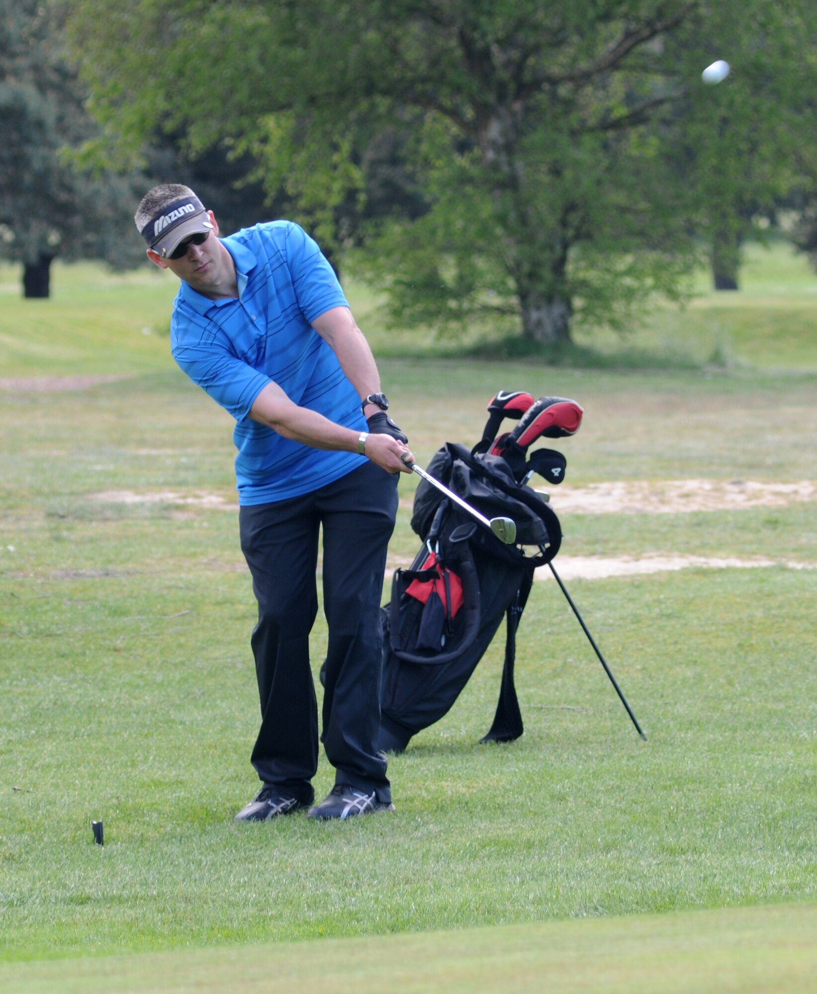 Tech. Sgt. Steven Ransted, 100th Maintenance Squadron unit deployment manager from Rosevile, Calif., plays his second shot just off the green at the 170-yard par-3 15th hole during intramural golf June 5, 2013, at the Breckland Pines Golf Club on RAF Lakenheath, England. The Maintenance Squadron won the hole with a one over par, bogey four. (U.S. Air Force photo by Gary Rogers/Released)