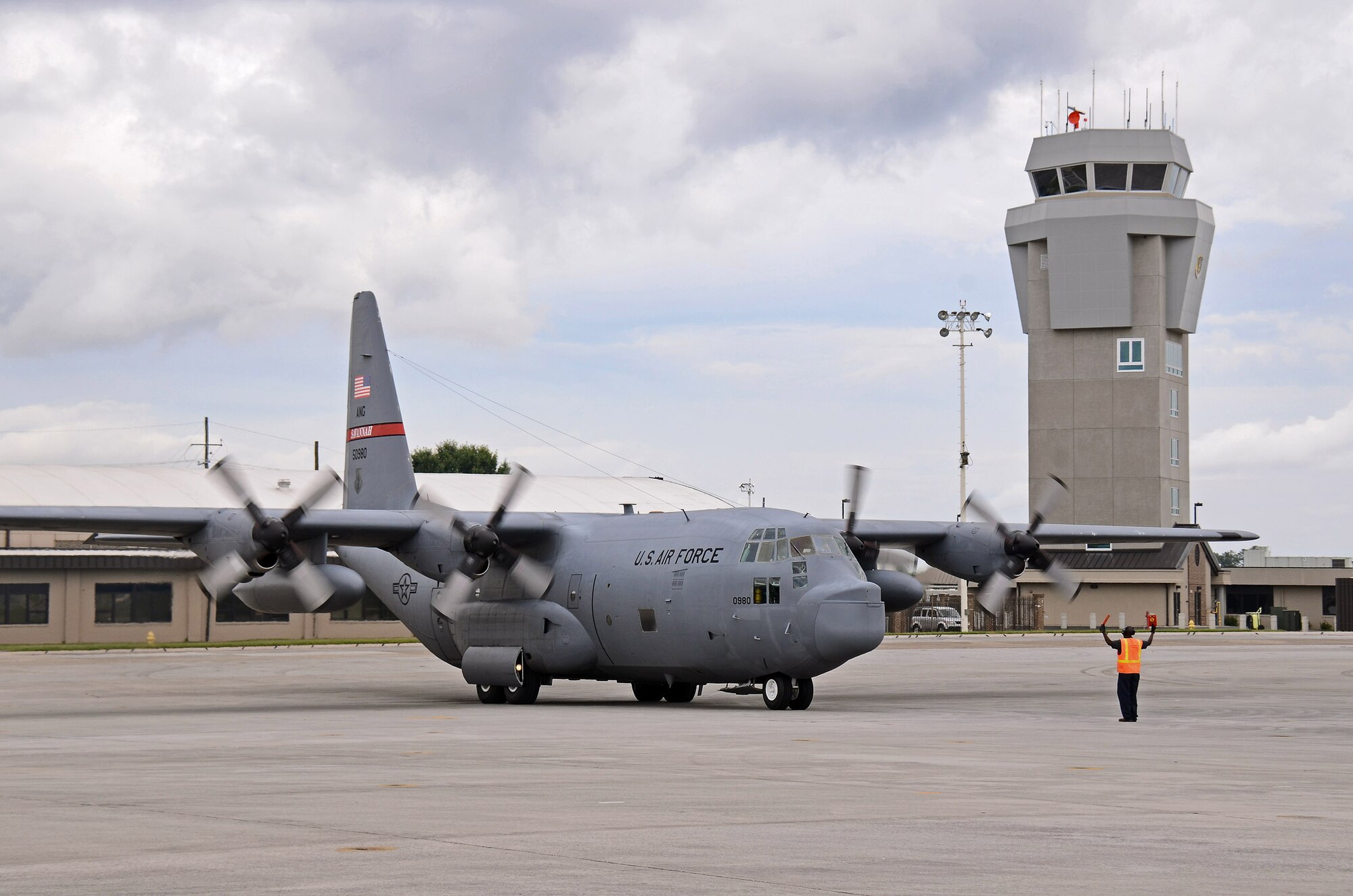 Lawrence Rogers, transient alert aircraft servicer, marshals a C-130 Hercules from the 165th Airlift Wing of the Georgia Air Guard at Savannah, into a parking space at Dobbins Air Reserve Base, Ga., Jun 6. Three aircraft evacuated from Savannah to Dobbins to avoid the path of tropical storm Andrea as it made its way across Florida and up the east coast. (U.S. Air Force photo/Brad Fallin)