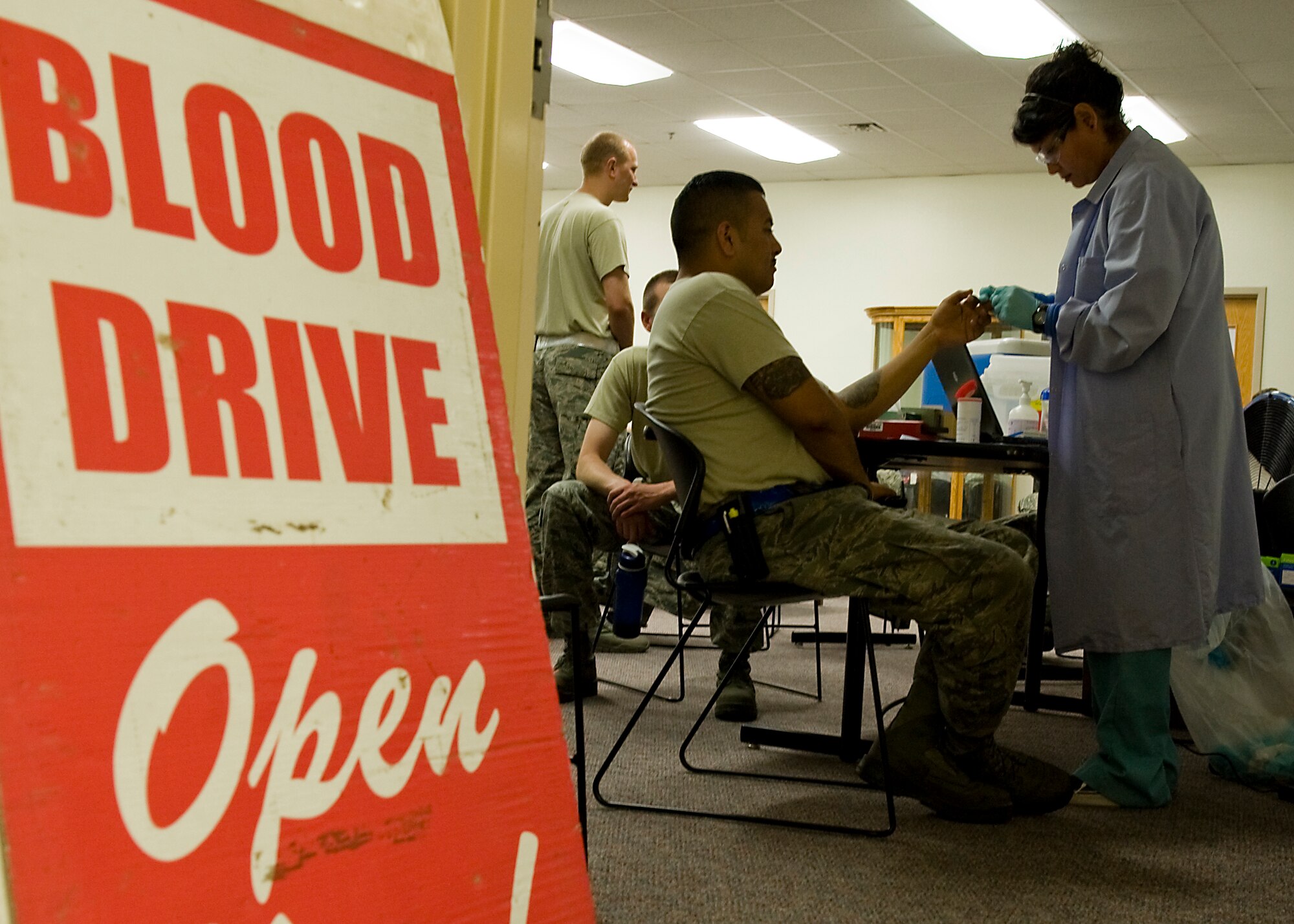 U.S. Air Force Senior Airman Rafael Trujillo, 7th Aircraft Maintenance Squadron, begins the process of donating blood by getting his vitals checked June 5, 2013, at Dyess Air Force Base, Texas. Airmen from the 7th AMXS worked with Meek Blood Center to organize a base blood drive. Nearly 1,000 pounds of clothing was also collected at the event and Airman wrote on banners, which will be delivered to victims in areas of Oklahoma most affected by recent natural disasters. The event gathered nearly 1,000 pounds of clothing and had more than 45 registered blood donors who gave both whole blood and double red blood cells. This is the second year the squadron has hosted a blood drive with hopes of making it a bi-annual event. The blood collected will be distributed to where it is needed most by the Red Cross. The Meek Blood Center will be returning to Dyess July 17, 2013. (U.S. Air Force photo by Airman 1st Class Peter Thompson/Released)