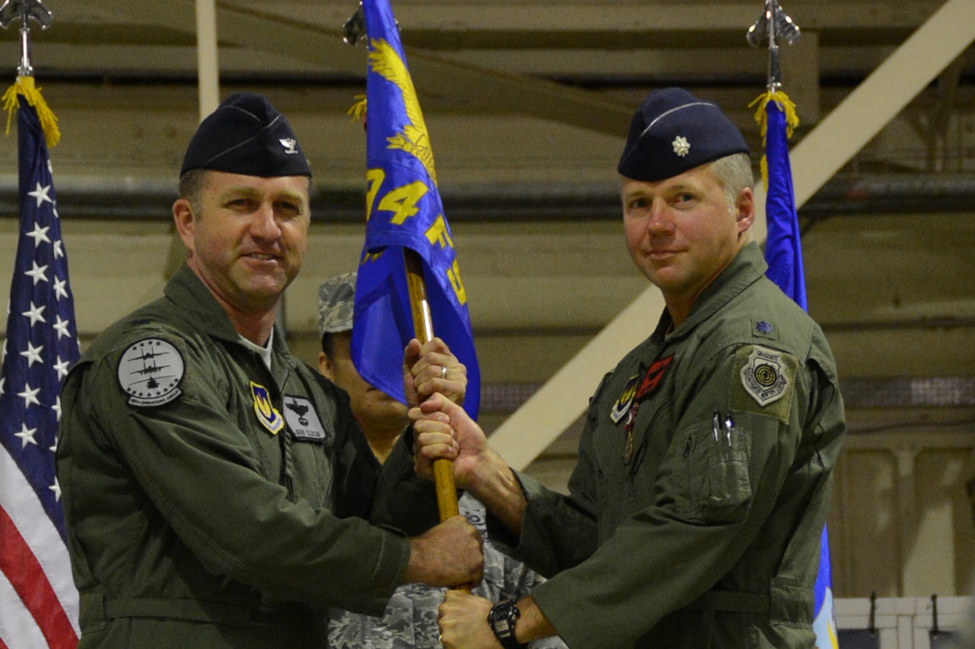 ROYAL AIR FORCE LAKENHEATH, England – Lt. Col. Daniel Rauch, (right) outgoing 494th Fighter Squadron commander, relinquishes command of the 494th FS to Col. Mark Slocum, 48th Operations Group commander, during a change of command ceremony June 6, 2013. The change of command ceremony is a tradition that represents a formal transfer of authority and responsibility. (U.S. Air Force photo by Airman 1st Class Trevor T. McBride)
