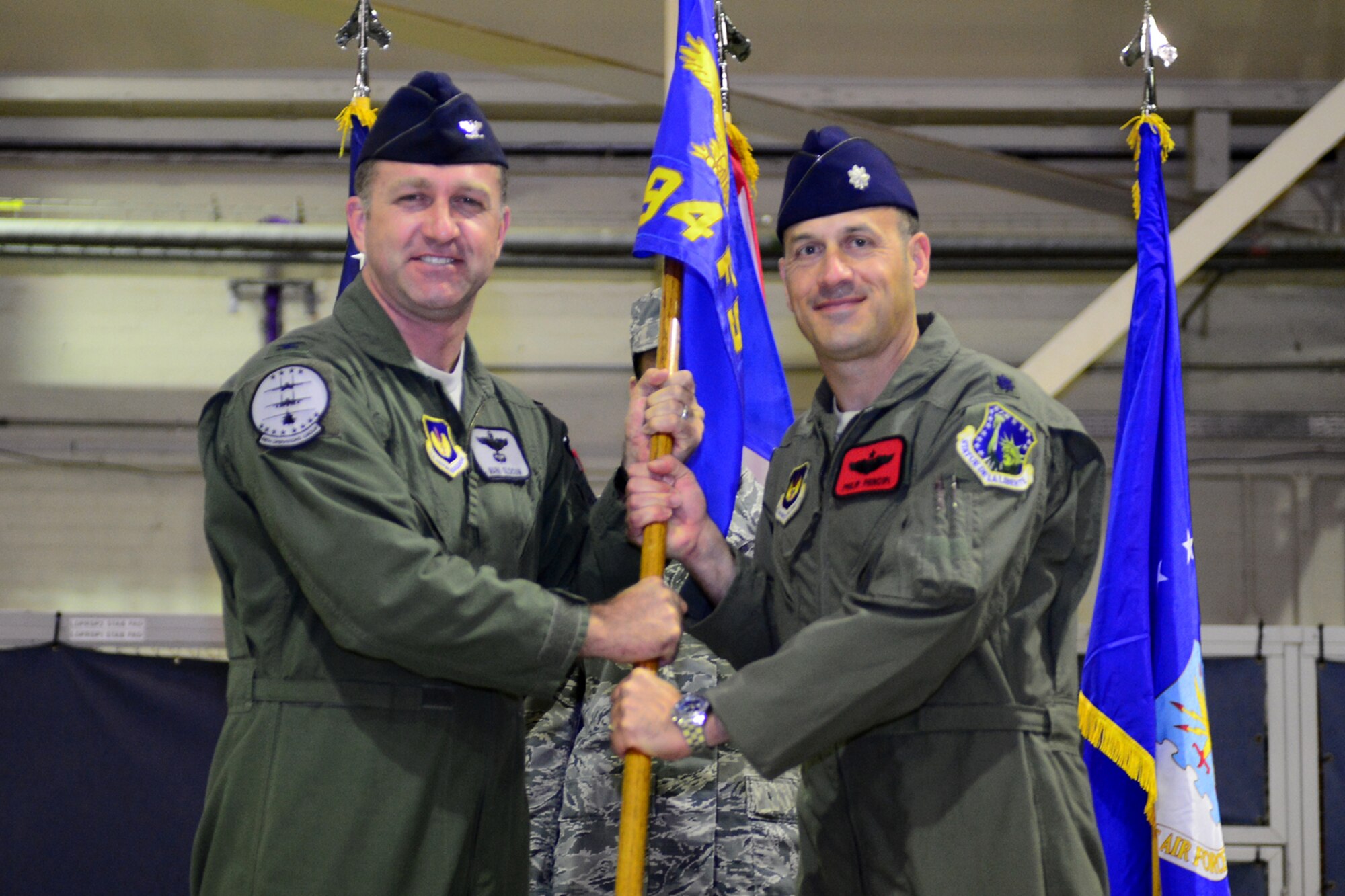 ROYAL AIR FORCE LAKENHEATH, England – Col. Mark Slocum, (right) 48th Operations Group commander, passes the 494th Fighter Squadron guidon and command of the 494th FS to Lt. Col. Philip Principi, former 492nd FS director of operations, during a change of command ceremony June 6, 2013. The change of command ceremony is a tradition that represents a formal transfer of authority and responsibility. (U.S. Air Force photo by Airman 1st Class Dana J. Butler)
