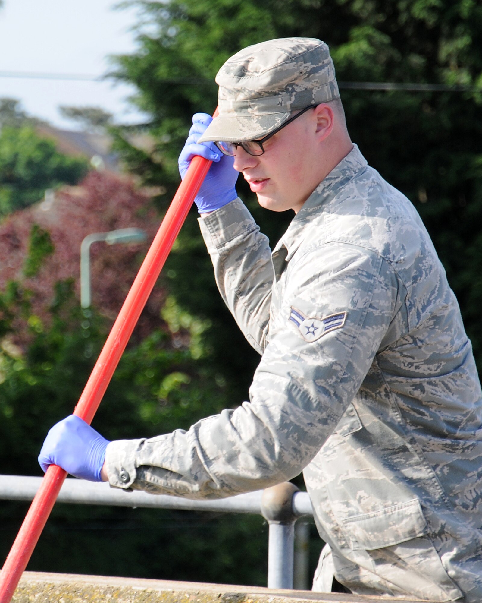 Airman 1st Class Justin Krah, 100th Civil Engineer Squadron Water and Wastewater Plant operator from Shamokin, Pa., shows Chief Master Sgt. Tracy Jones, 100th Air Refueling Wing command chief, how to scrub the primary clarifier June 6, 2013, at RAF Mildenhall, England. Water plant personnel showed Jones how they contribute to the mission as part of a “dirty jobs” initiative. (U.S. Air Force photo by Gina Randall/Released)