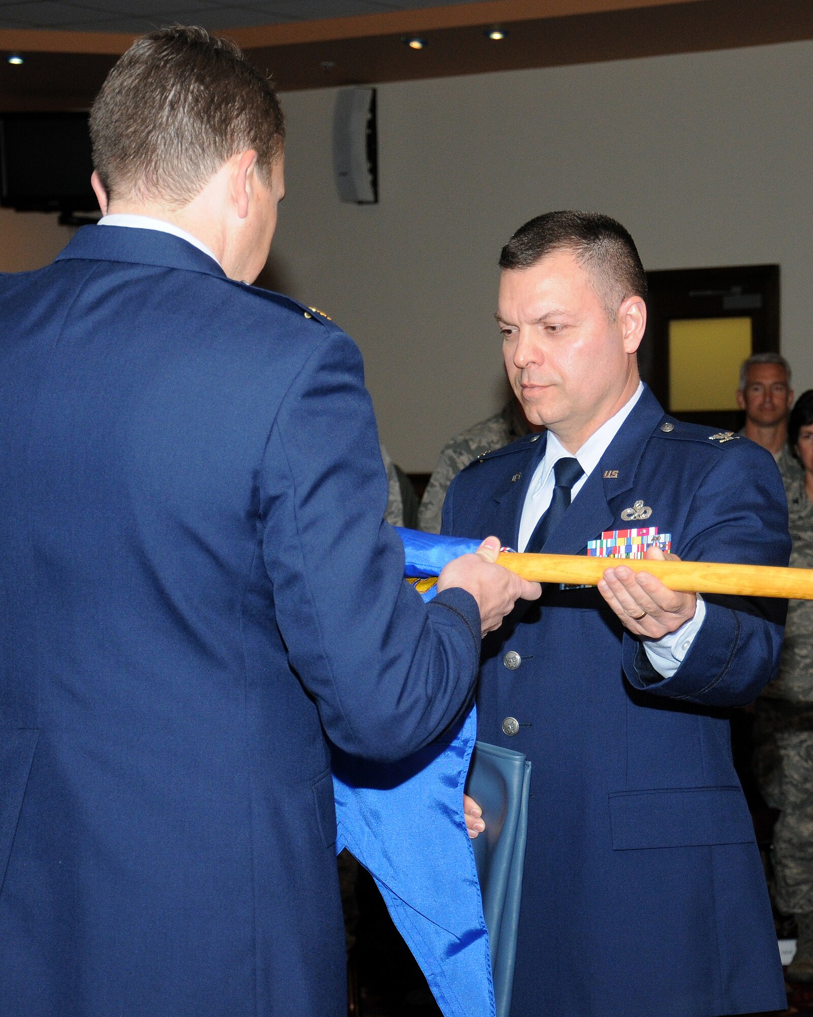 From right, Col. Joseph Rushlau, 100th Maintenance Group commander, and Maj. Marc Albritton, 100th Maintenance Operations Squadron commander, perform a flag furling and sheathing during an inactivation ceremony June 3, 2013, on RAF Mildenhall, England. The ceremony was to mark the inactivation of the 100th MOS. (U.S. Air Force photo by Gina Randall/Released)