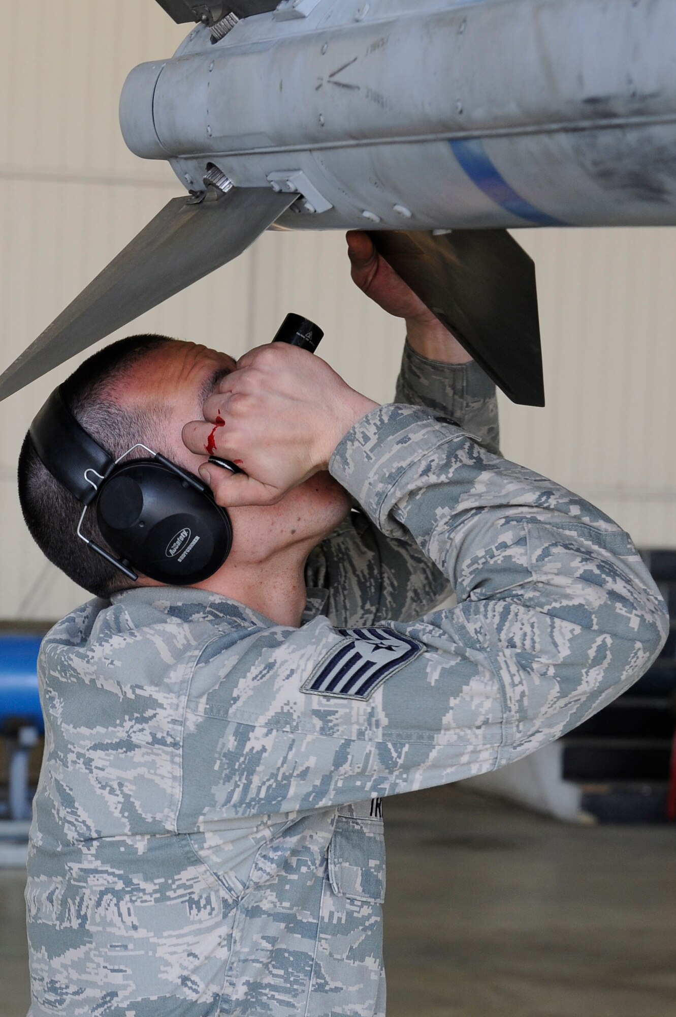 Staff Sgt. Joshua Truth, 8th Aircraft Maintenance Squadron, 80th Aircraft Maintenance Unit, weapons load crew team chief, secures fins onto an AIM-120 Advanced Medium-Range Air-to-Air Missile during a weapons loading competition at Kunsan Air Base, Republic of Korea, March 29, 2013. The 80th AMU won the last couple quarterly weapons loading competitions, but were unable to defend their title. (U.S. Air Force photo by Senior Airman Marcus Morris/Released)  