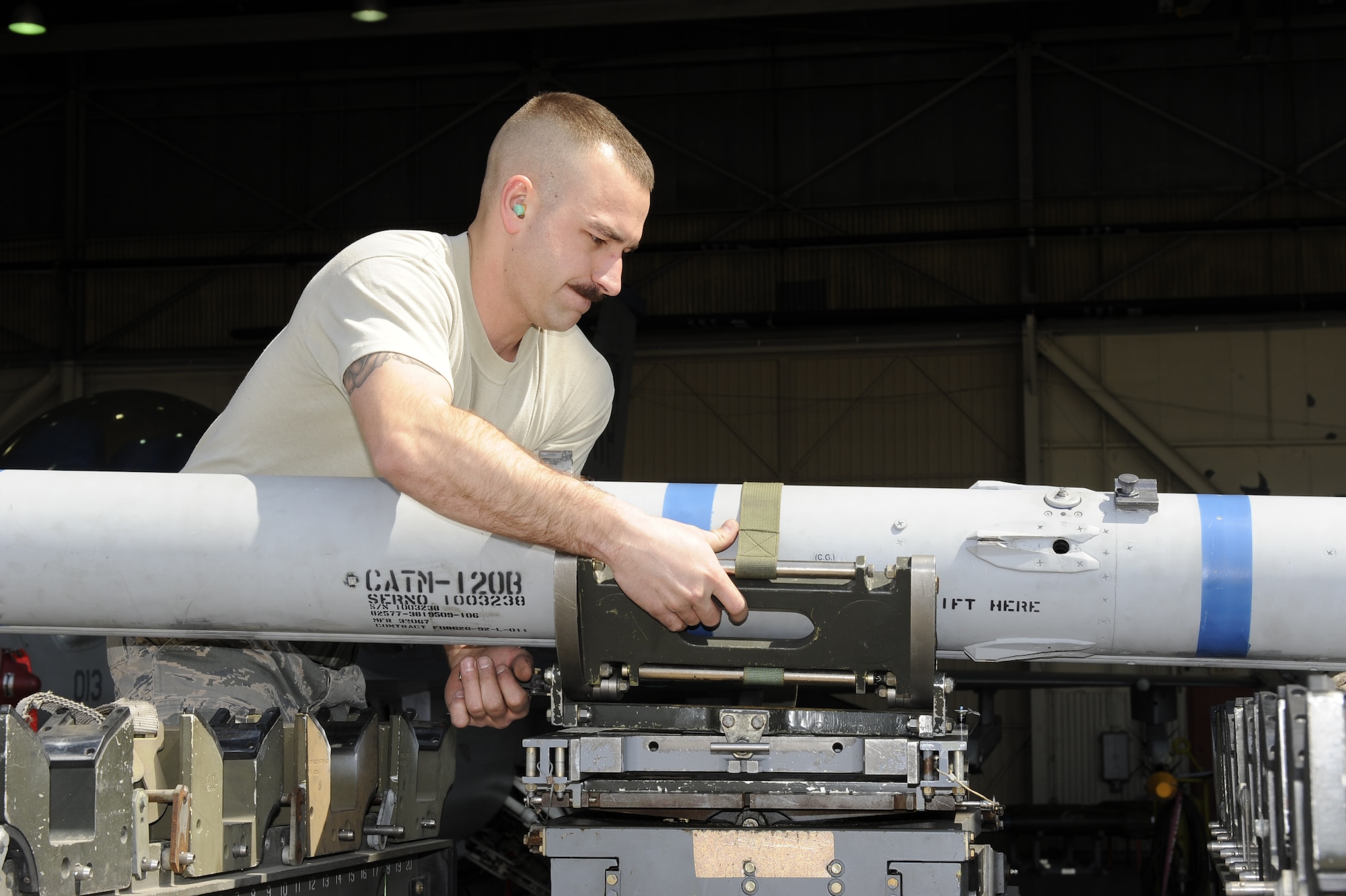 Staff Sgt. Gregory Harrison, 8th Aircraft Maintenance Squadron, 35th Aircraft Maintenance Unit, weapons load crew team chief, attaches an AIM-120 Advanced Medium-Range Air-to-Air Missile onto a bomb loader at Kunsan Air Base, Republic of Korea, March 29, 2013. Harrison’s crew took first place in the first quarterly weapons loading competition against the 8th AMXS, 80th AMU and the 4th Expeditionary Aircraft Maintenance Unit, Hill Air Force Base, Utah. (U.S. Air Force photo by Senior Airman Marcus Morris/Released)  