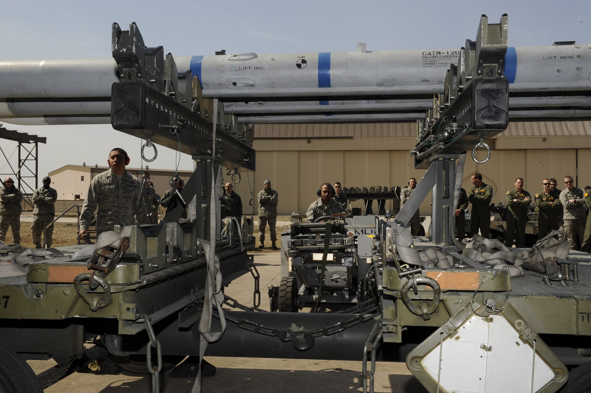 8th Aircraft Maintenance Squadron weapons load crew member, Senior Airman Marcus Mitchell, 80th Aircraft Maintenance Unit positions a bomb loader underneath a AIM-120 Advanced Medium-Range Air-to-Air Missile during a weapons loading competition between the 8th AMXS 35th AMU and the 4th Expeditionary Aircraft Maintenance Unit, Hill Air Force Base, Utah at Kunsan Air Base, Republic of Korea, March 29, 2013. The Airmen had 40 minutes to load six missiles and were graded on speed and efficiency. (U.S. Air Force photo by Senior Airman Marcus Morris/Released)  