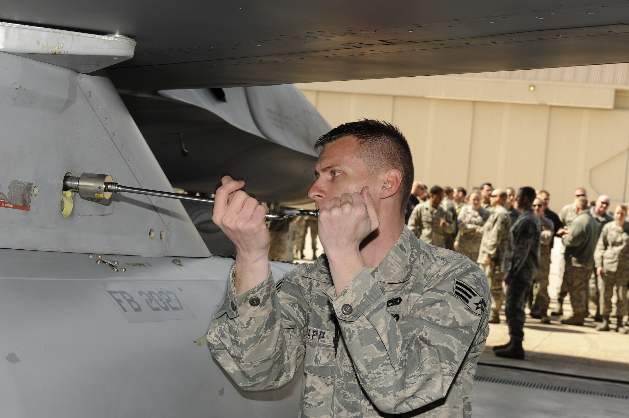 Senior Airman Andrew Rapp, 4th Expeditionary Aircraft Maintenance Unit, Hill Air Force Base, Utah attaches a bolt to an F-16 Fighting Falcon during a weapons loading competition against 8th Aircraft Maintenance Squadron load crew members from the 35th Aircraft Maintenance Unit and the 80th AMU at Kunsan Air Base, Republic of Korea, March 29, 2013. The Airmen were graded on their efficiency and promptness to load six missiles within 40 minutes. (U.S. Air Force photo by Senior Airman Marcus Morris/Released)  